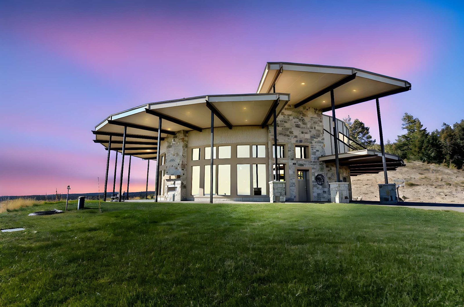 West Ultimate Retreat — cantilevered cabin against pink sunset sky