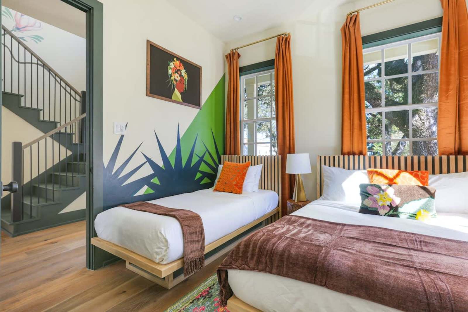 Painted agave leaves rising up a bedroom wall