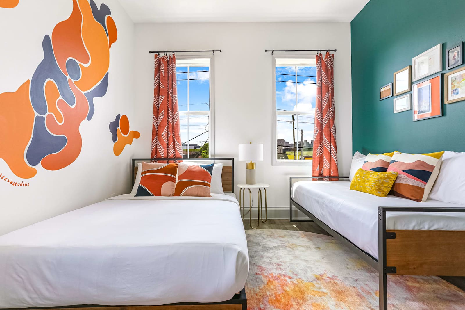 Painted orange and coral forms across a bedroom wall