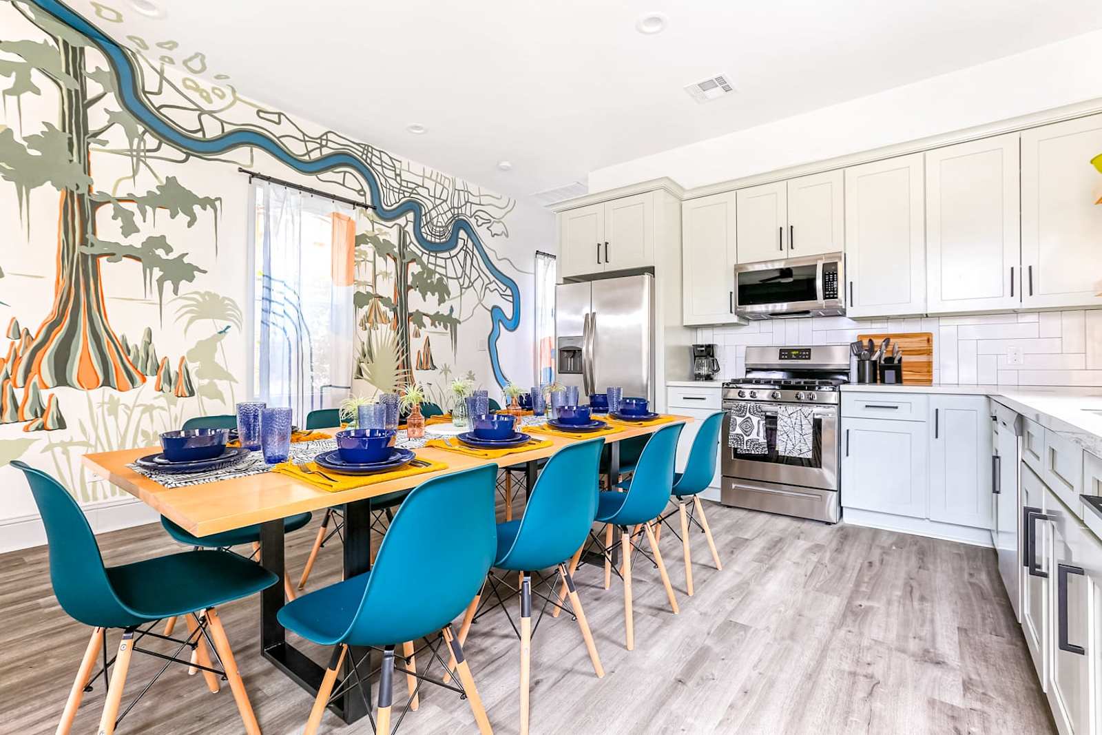 A cypress bayou mural running above the dining table