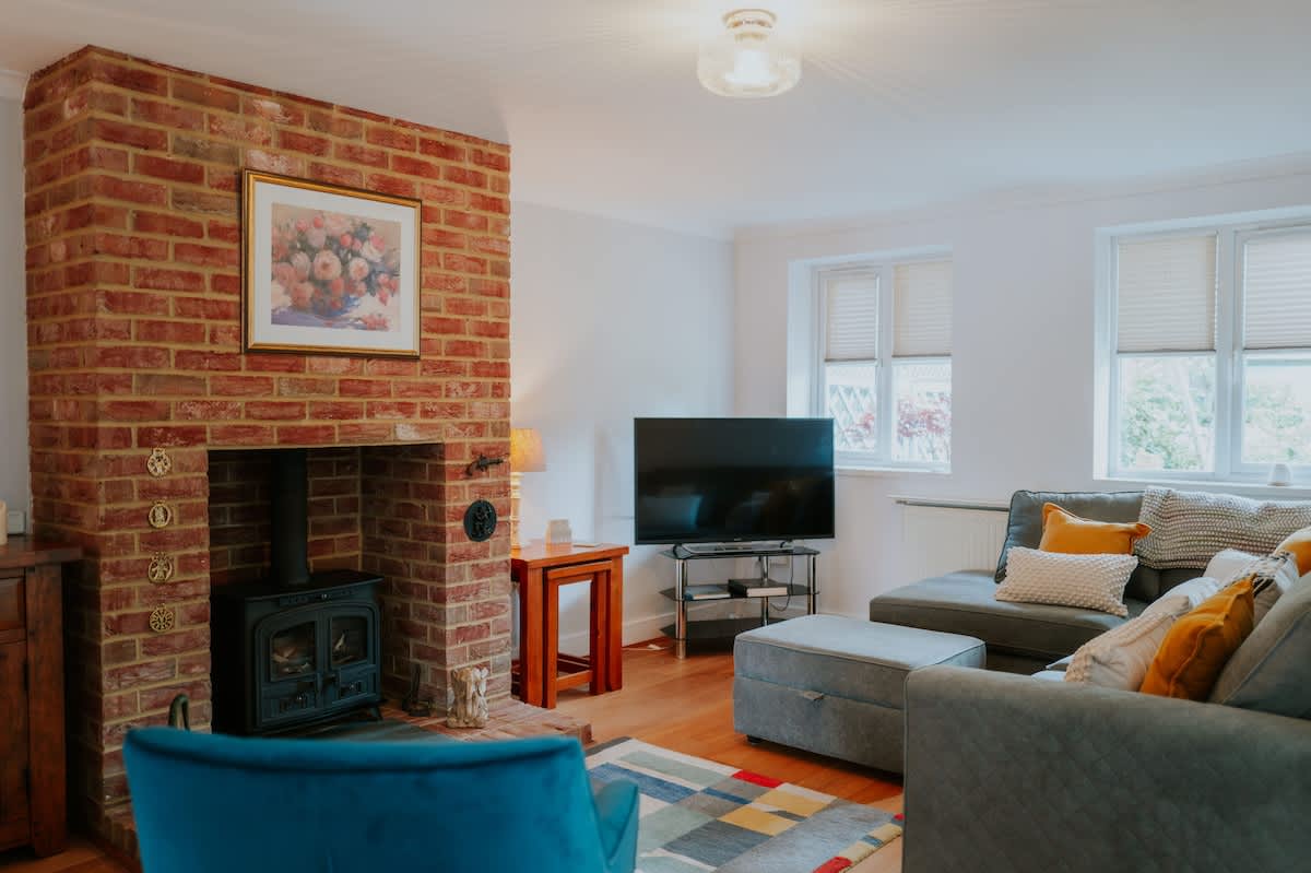 Living room with a brick fireplace in our Headcorn house