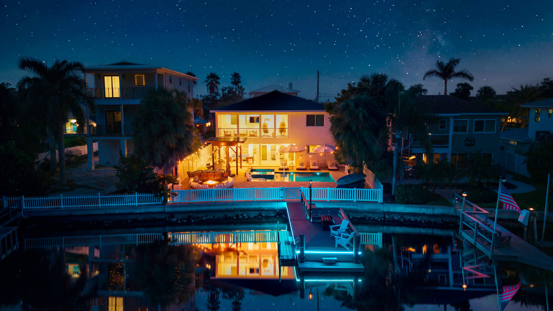 Waterfront vacation home glowing at night on Florida's Gulf Coast