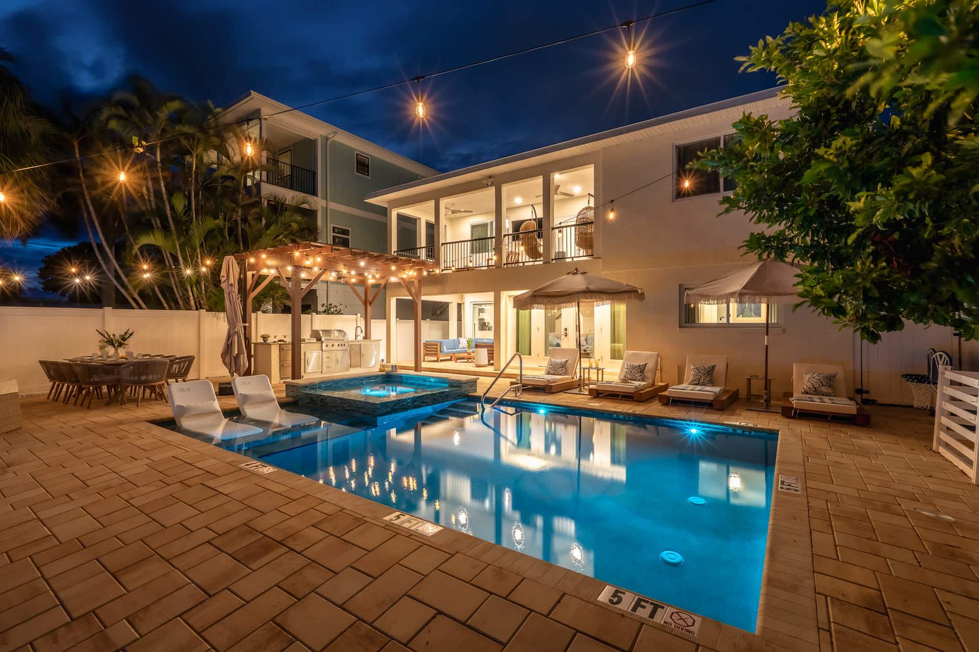 Heated private pool and vacation home at dusk
