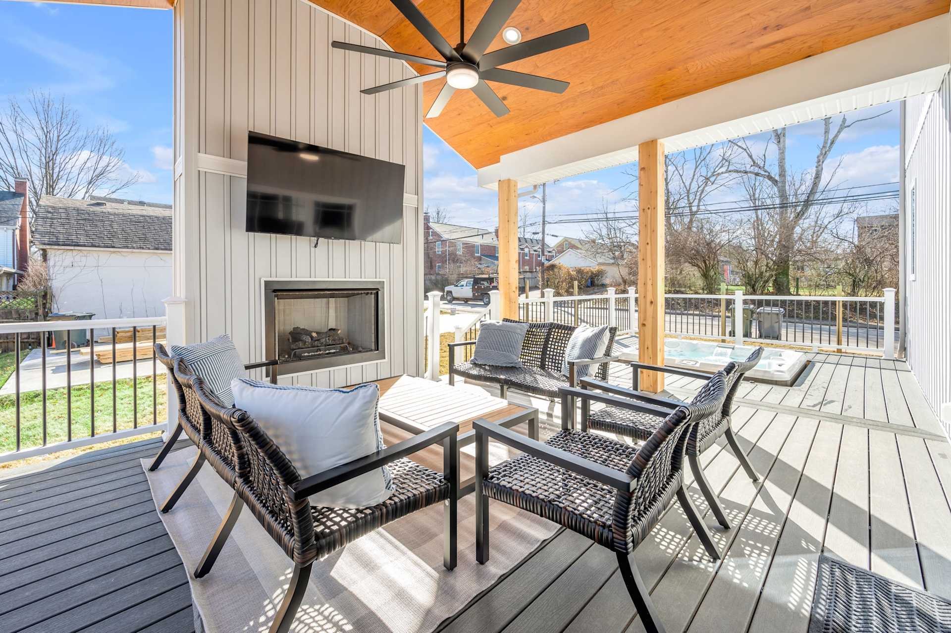 Relax on your covered deck year-round: pull up a chair by the fireplace, flip on the mounted TV, and let your evening stretch long.