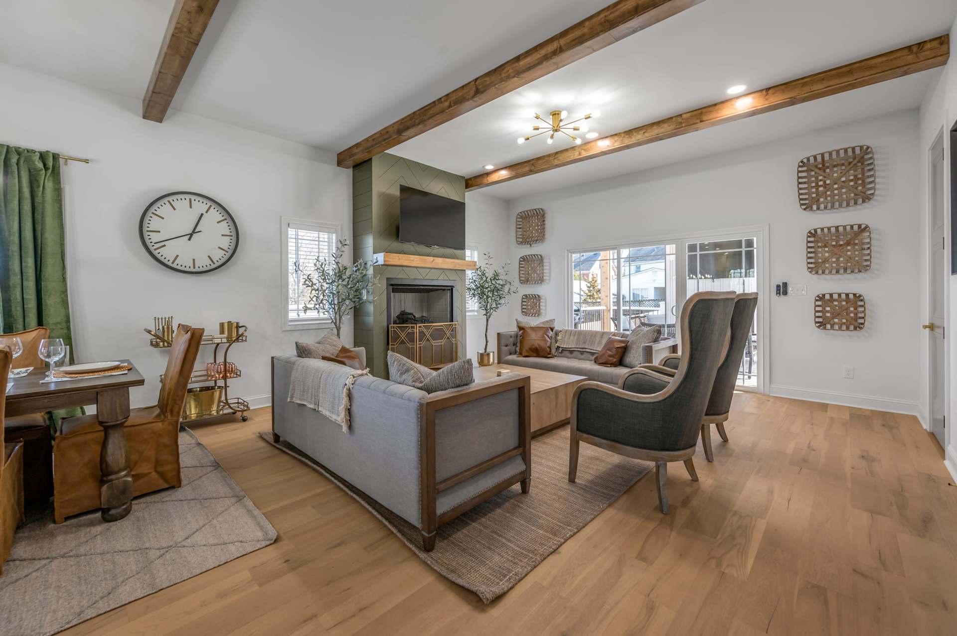 Sink into the plush sofa beneath your soaring beamed ceilings — this vaulted living room, warmed by a fireplace, is where your whole group naturally gathers.