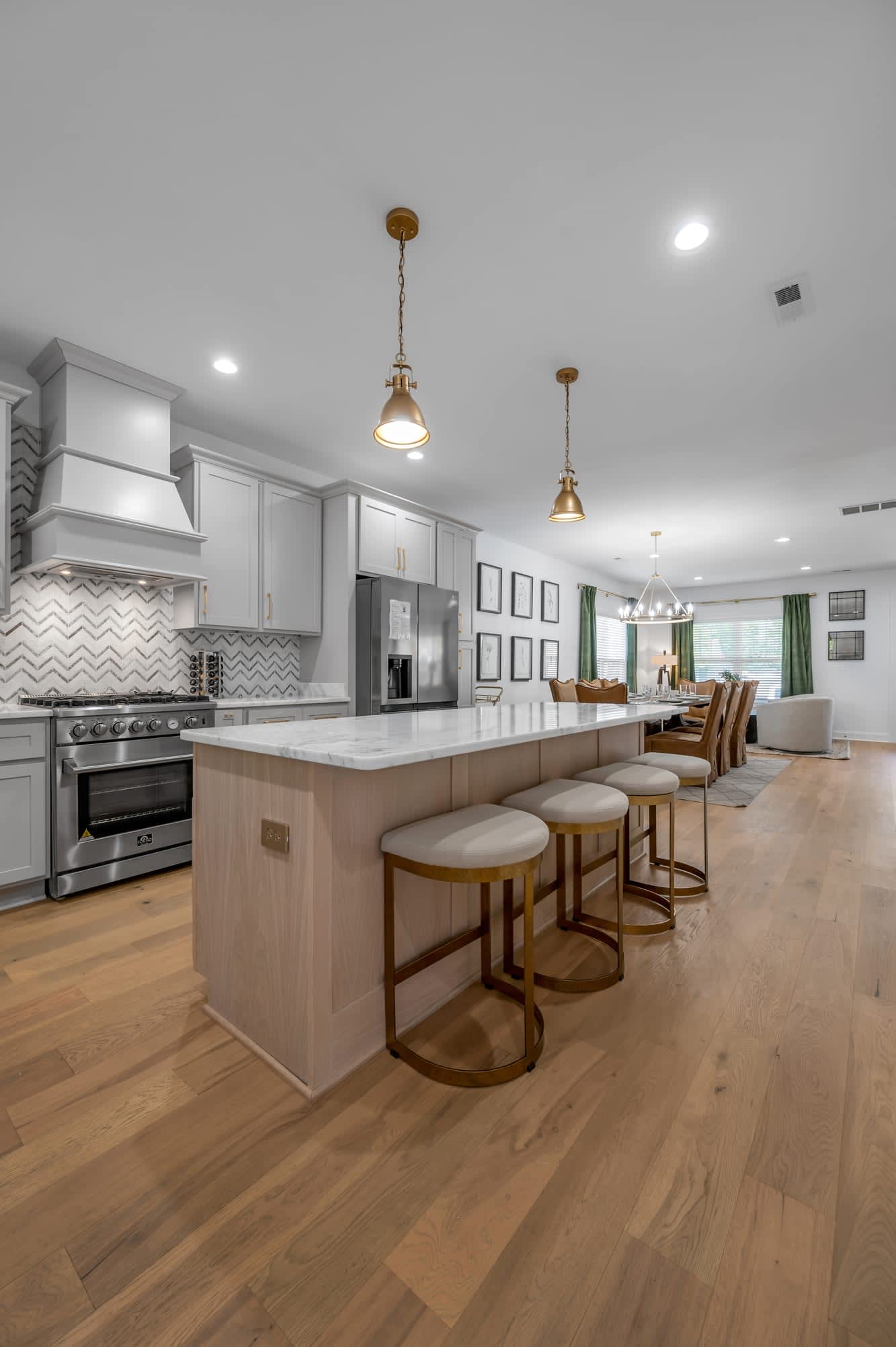 Cook together, eat together — the island seats four and opens straight into the dining room, so nobody misses the conversation while dinner is on the stove.