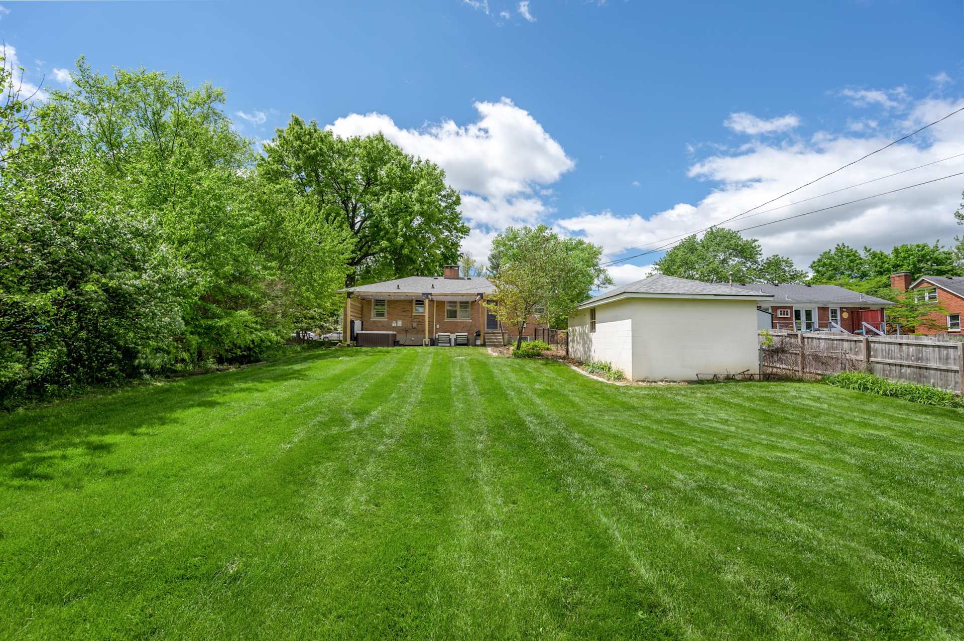 Let the kids and the dogs tear around a fully fenced backyard while you watch from the patio — room to run, total privacy, and nobody chasing anyone toward the street.