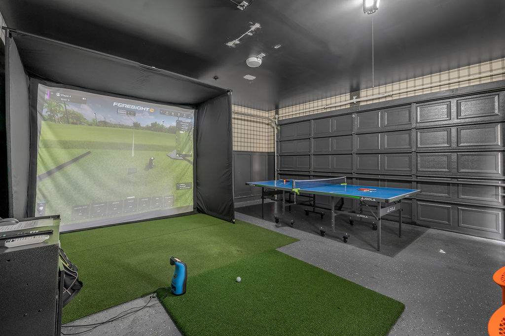 Step into the Foresight Sports golf simulator room — a setup most people pay green fees to access. Putting surface underfoot, ping pong across the room, rain-day agenda that practically writes itself.