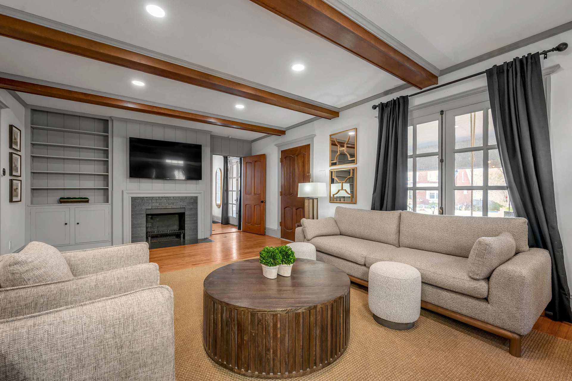 Kick your boots off and claim the couch — the fireplace crackling, the big TV on for the game, this is the room where the group actually slows down together.