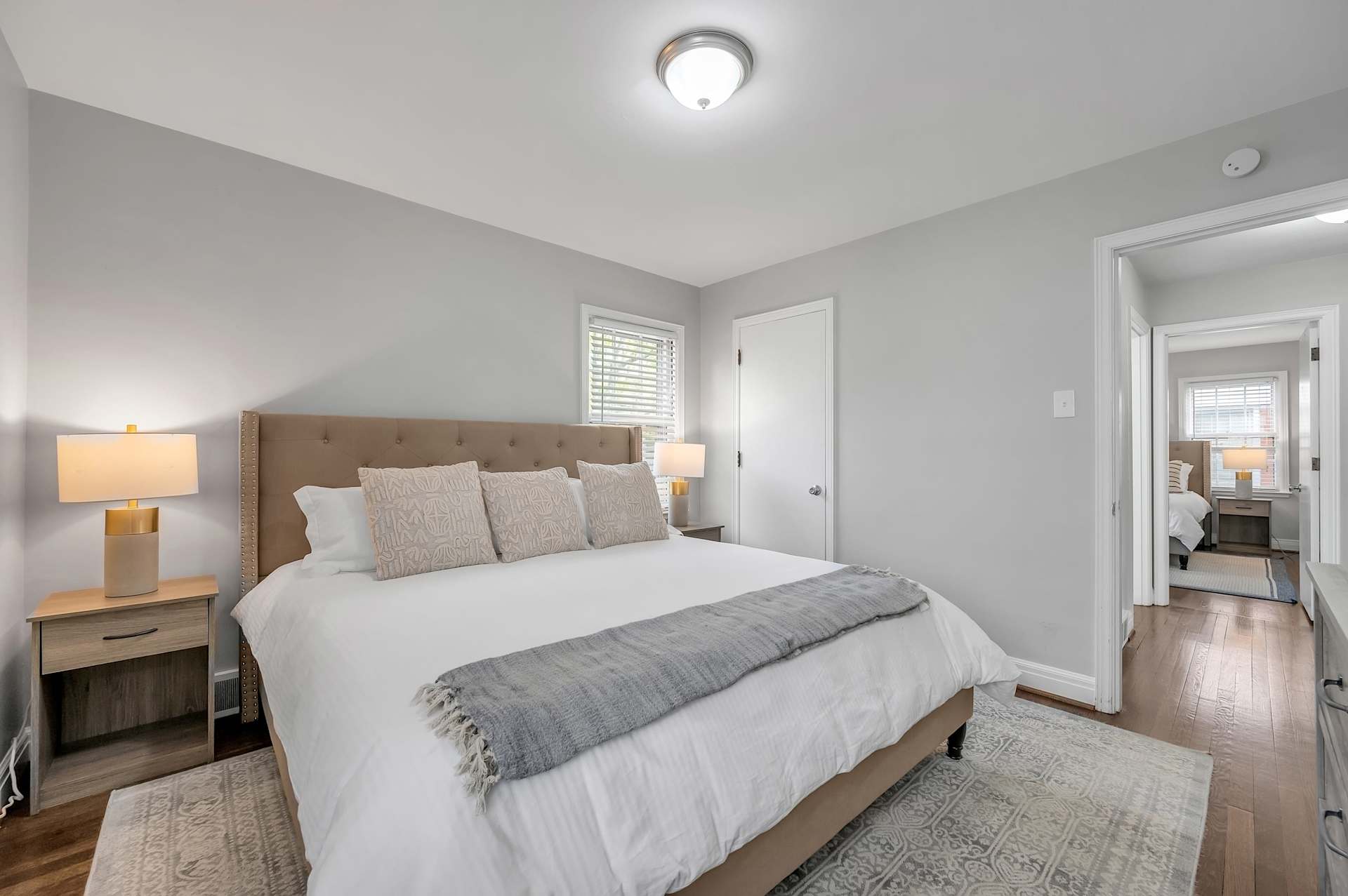 The main-floor king bedroom — comfortable, bright, and steps from the kitchen. Modern decor, natural light, and the kind of rest that sets the tone for a great trip.