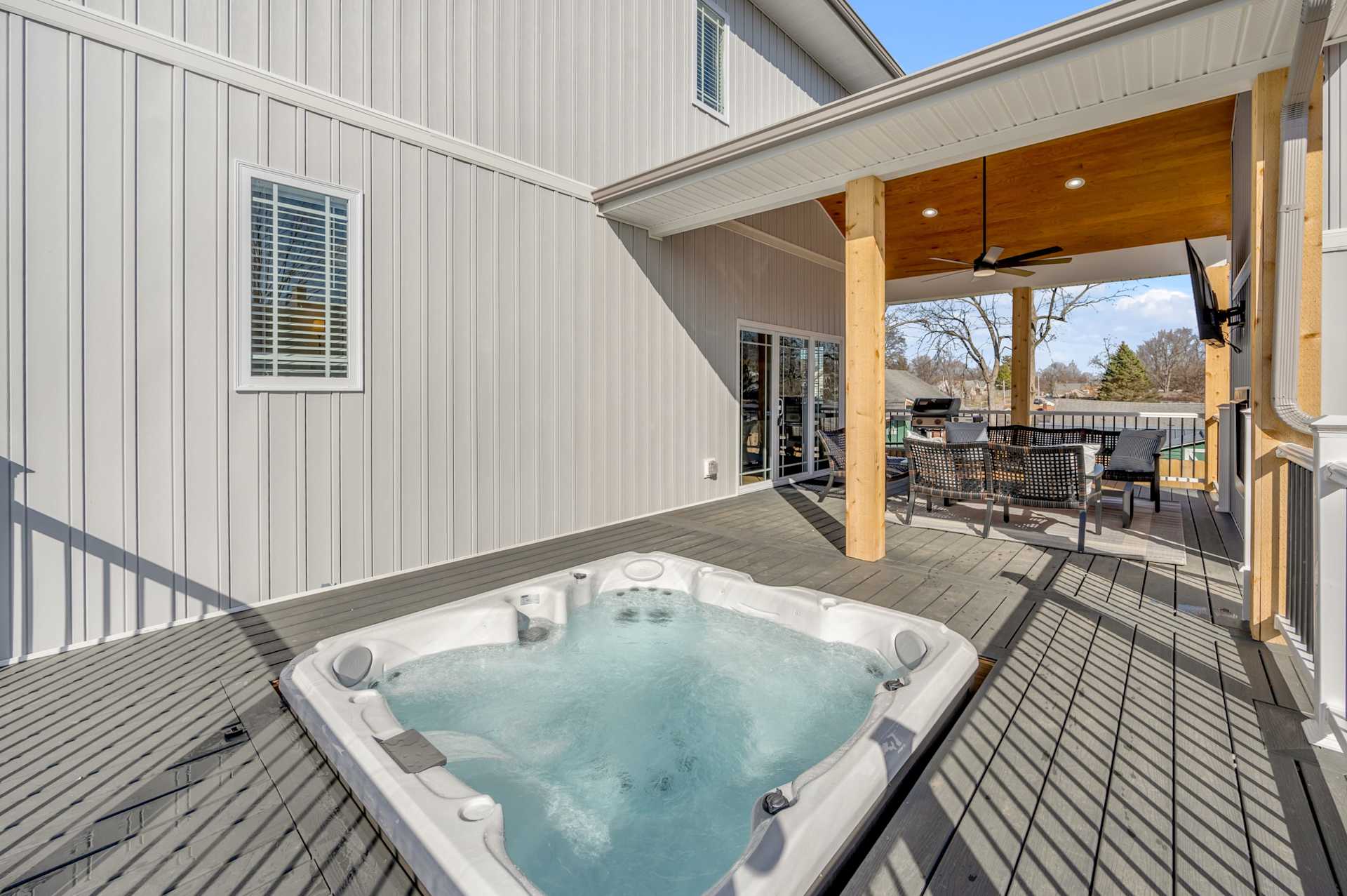 Soak under the open sky in your private hot tub, framed by modern seating and a serene view — the after-dark ritual your group will fight over.