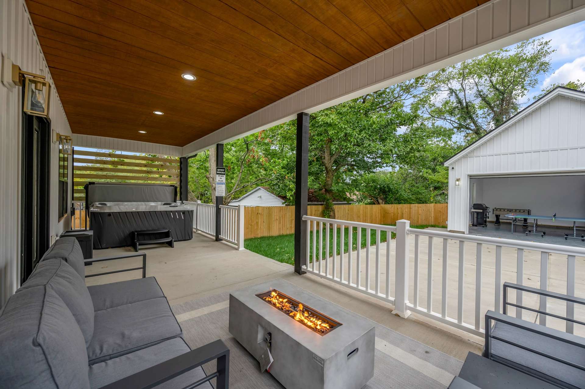 Trade the hotel balcony for a private hot tub and a fire pit under your own covered porch — this is where the night actually starts.