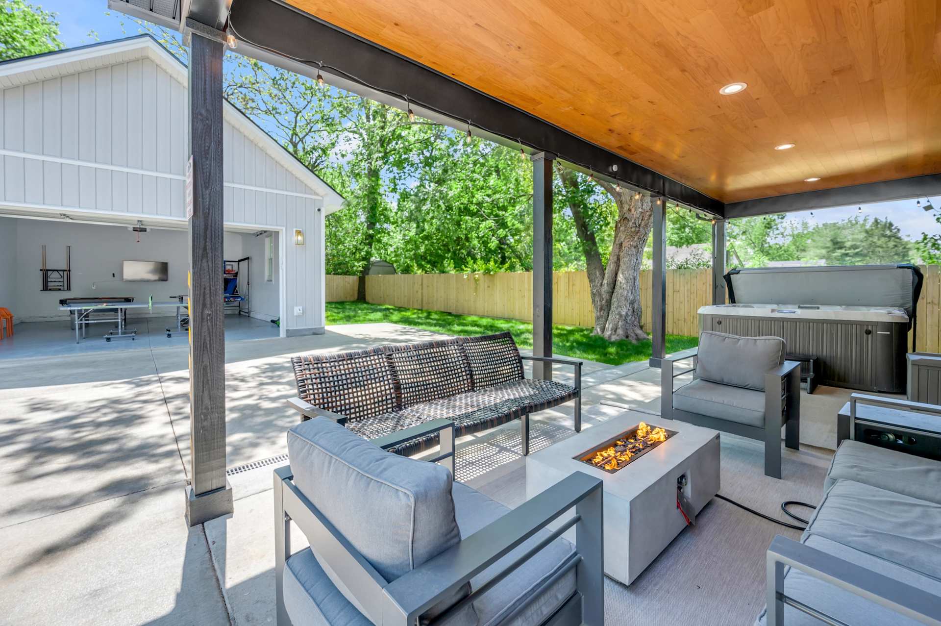 Soak in the hot tub while everyone else gathers around the fire table on the covered porch — your private outdoor hangout, ready any night of the week.