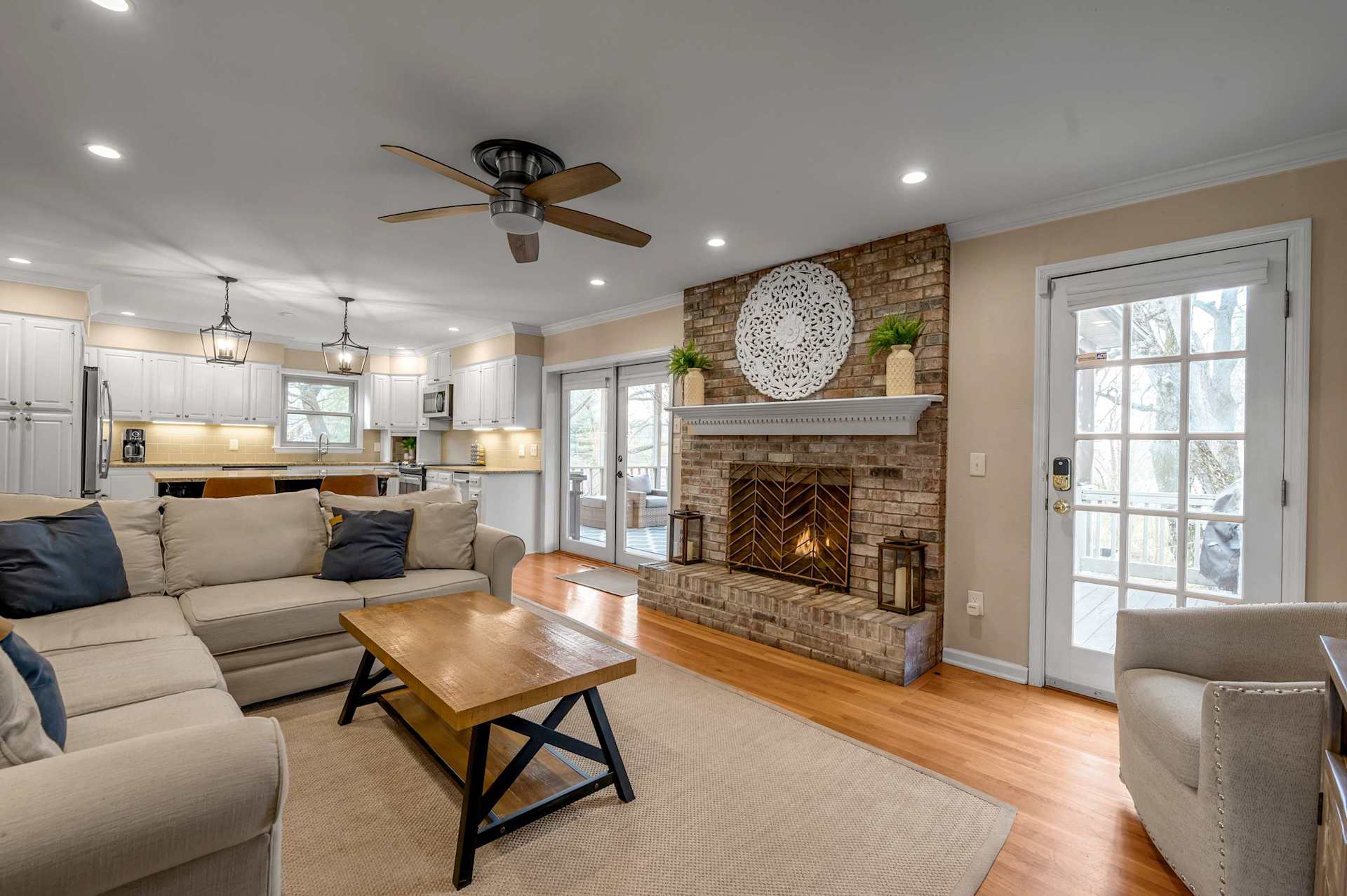 Kick your shoes off and sink into the sectional — the fireplace crackling, the kitchen just steps away, and the whole group gathering here before anyone even unpacks.