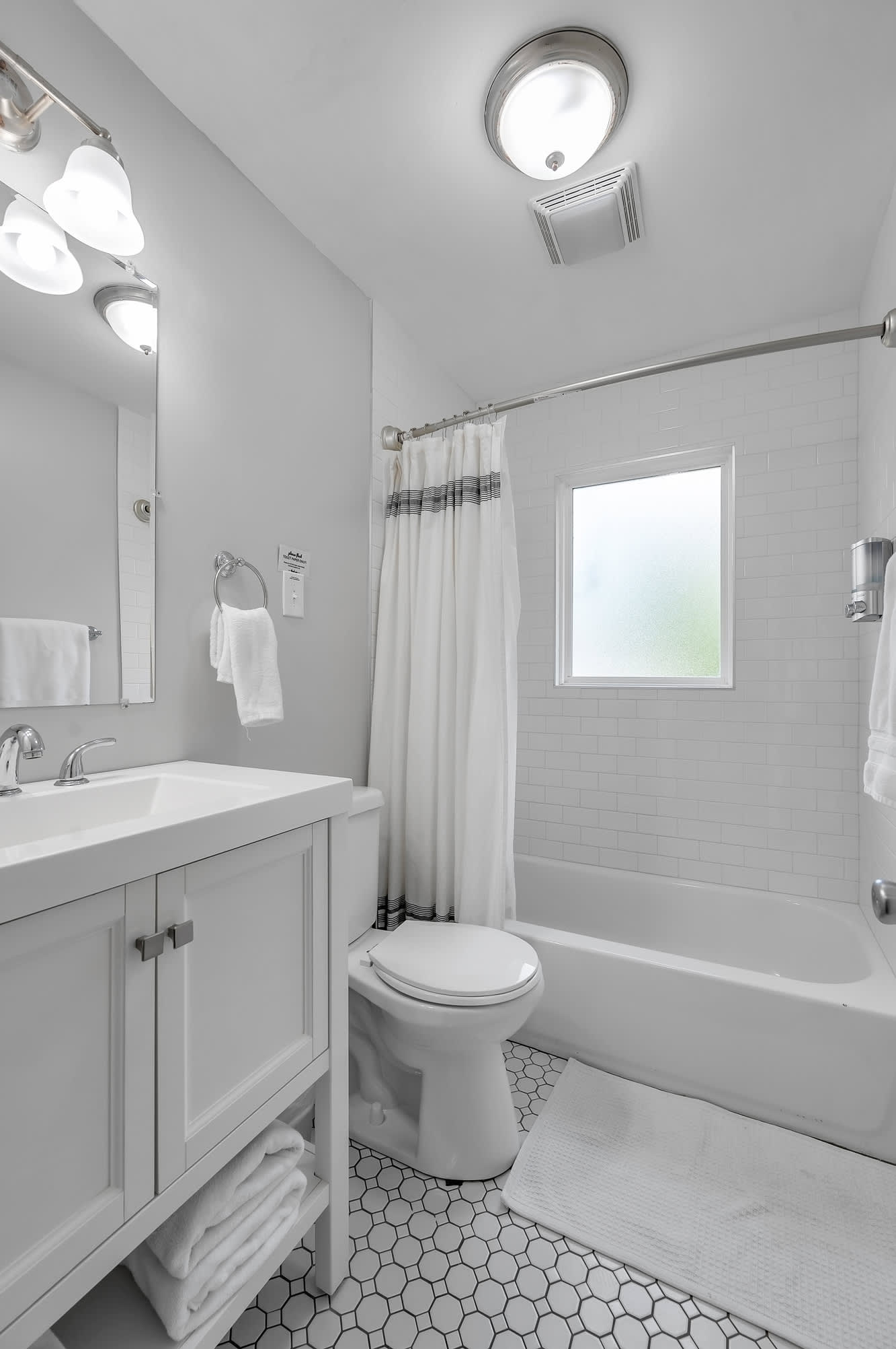 This 1st-floor bathroom is the perfect place to unwind with its sleek design and bathtub-shower combo.
