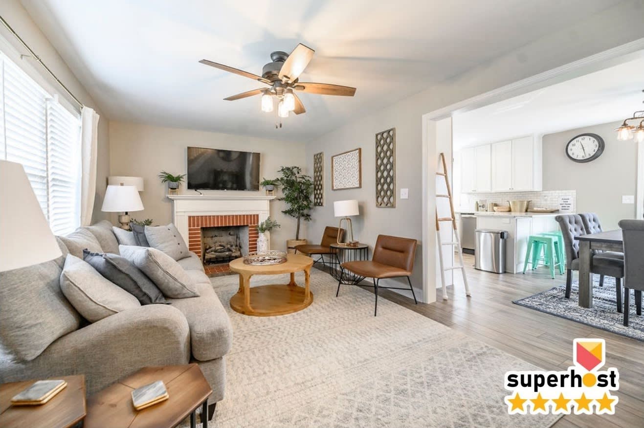Kick your shoes off the second you walk in — the fireplace crackling, the whole group spilling from the kitchen into the couch, this is where twelve people actually fit in one room.