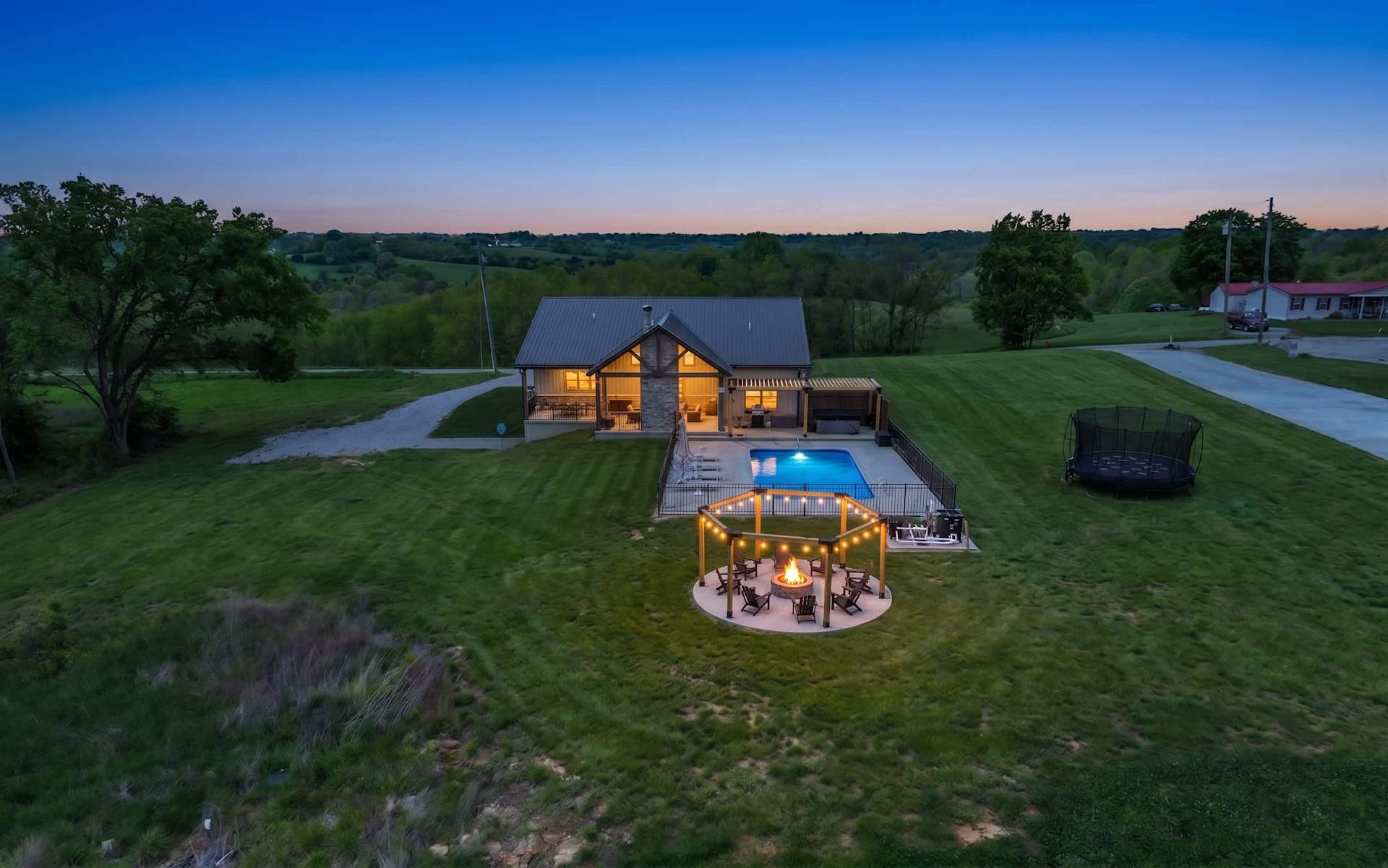 Picture your whole group scattered across the property from above — the pool and fire pit circle sit inside your own ten acres.