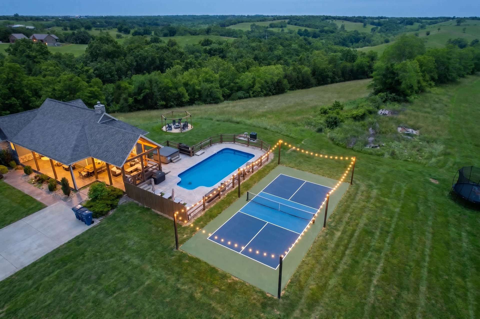 Private countryside retreat with a swimming pool, pickleball court, and beautiful views of the surrounding rolling hills.