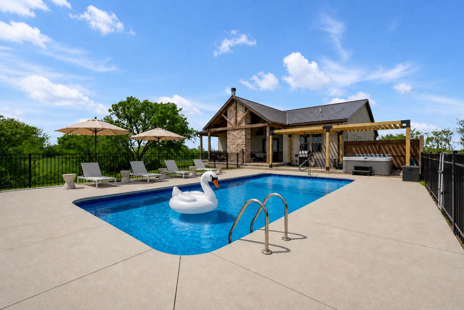 Ease into the pool with a float in hand while the hot tub steams just steps away under your own pergola — this is where your whole trip slows down.
