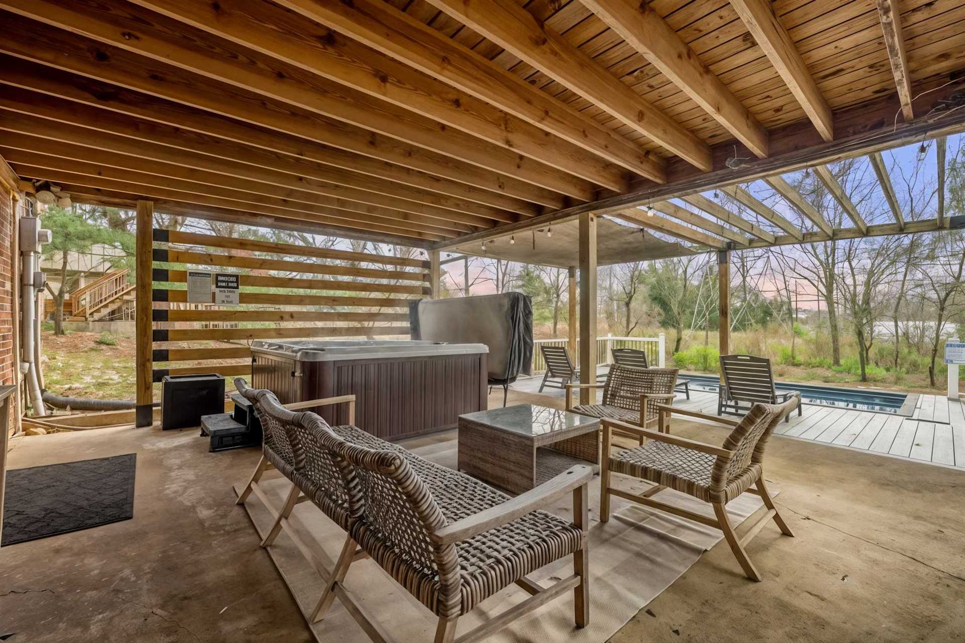 Trade the itinerary for a soak — slide into the hot tub, dangle your feet in the pool, and let the pergola shade do the rest of the work for you.