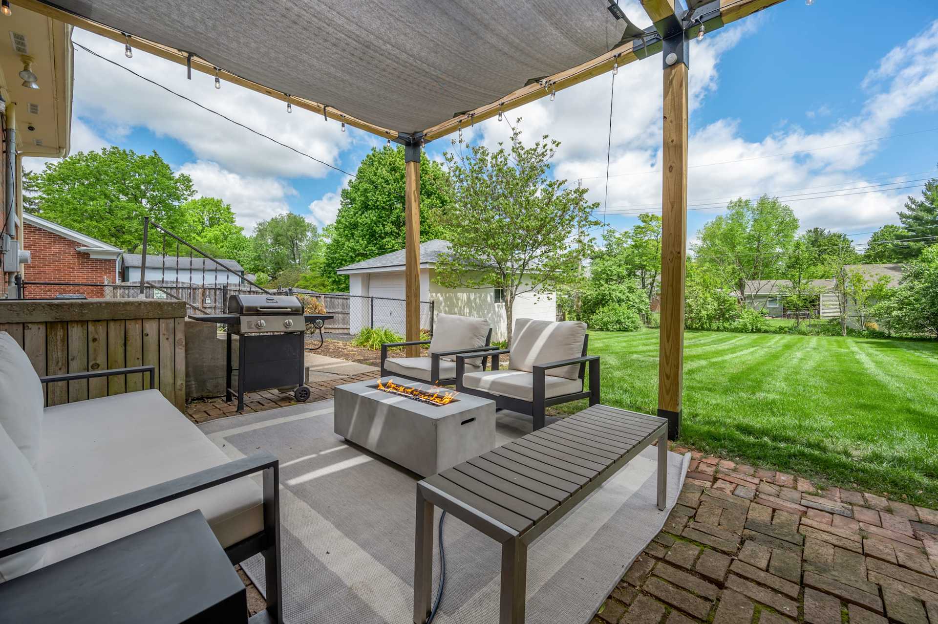 Gather around the fire table once the sun drops and let the conversation run long — the glow, the cool Kentucky evening, the whole crew pulled into one circle outside.
