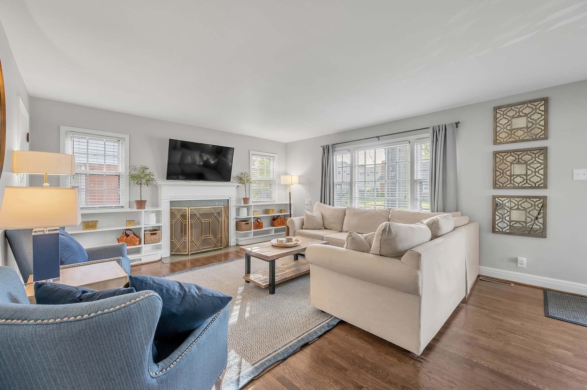 Relax in a spacious, light-filled living room featuring seating for up to 10 guests and a large smart TV. Contemporary décor, comfortable furnishings, and a warm, inviting atmosphere make it the perfect hub for gathering after a day of adventure.