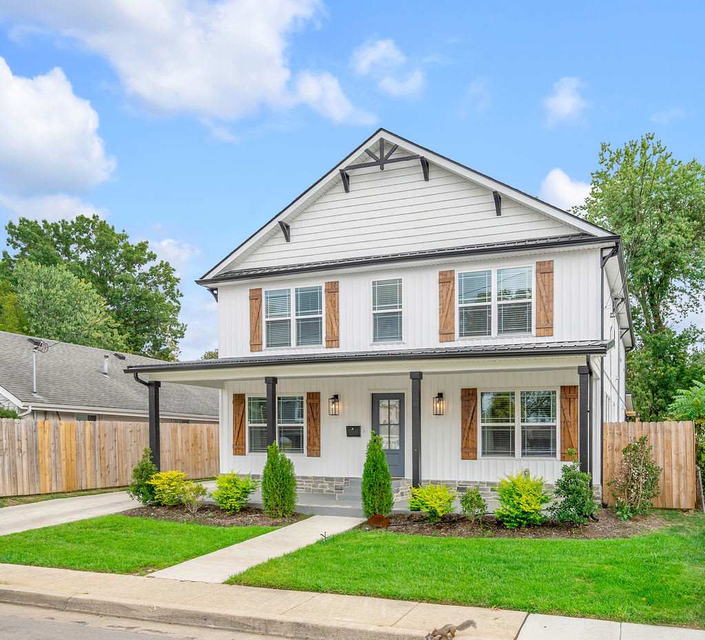 Pull into the driveway and the whole group already knows this is the one — white farmhouse, black shutters, a private corner lot with room for five cars and everyone who's coming with you.