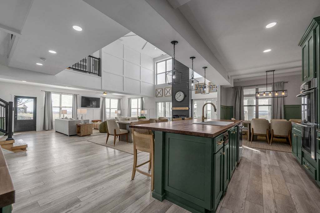Enjoy a bright open-concept space where the kitchen, dining, and living areas flow together under soaring ceilings.
