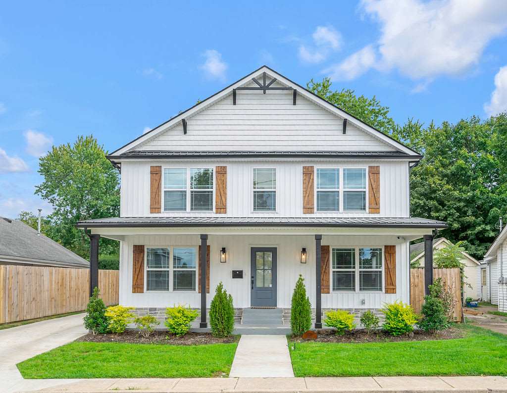 Pull into the driveway and feel the trip start right here — a wide covered porch and manicured lawn welcome your entire group home.