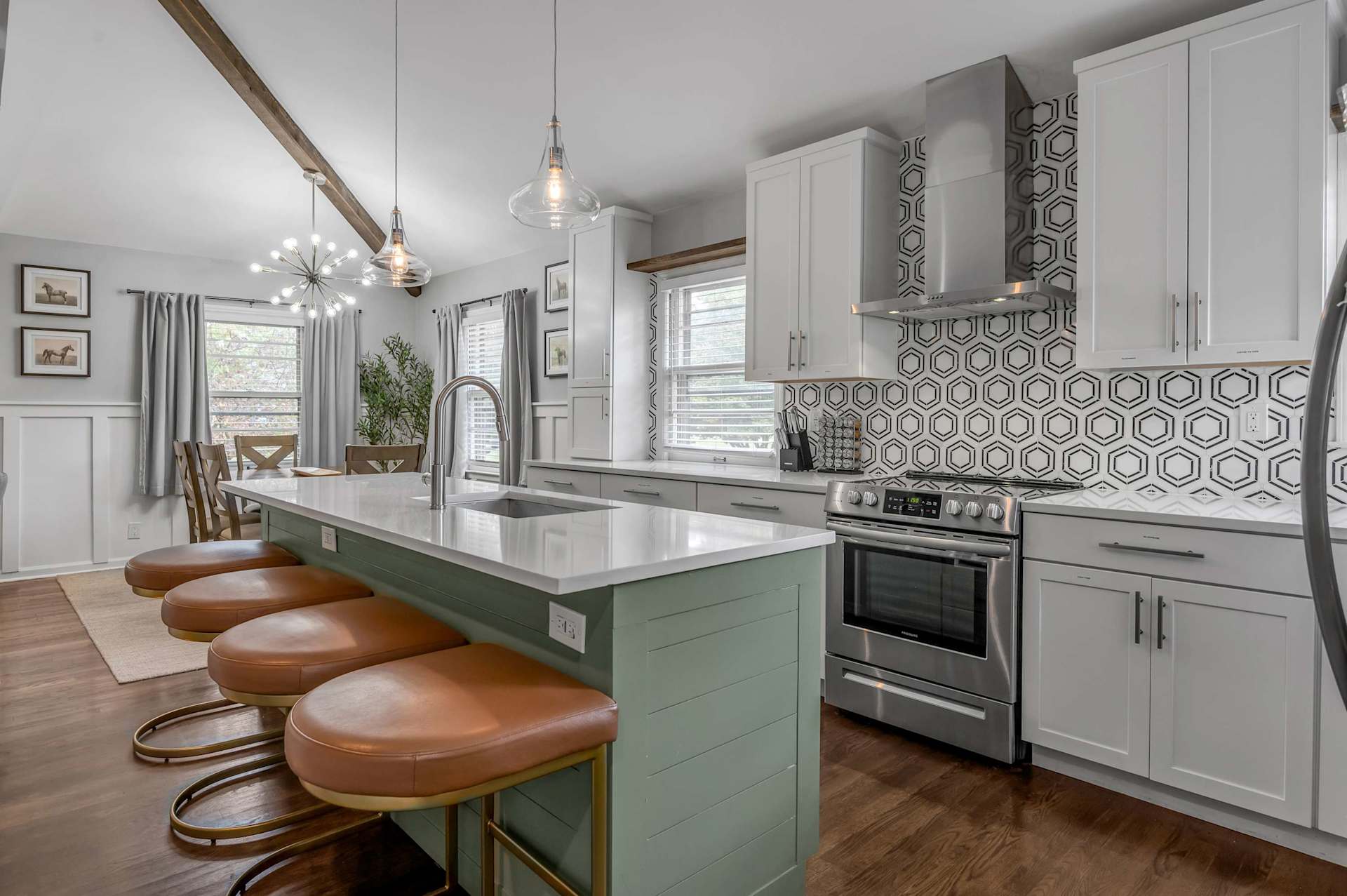 Pour the first cup of coffee at the island while everyone drifts in — this open kitchen is where your group lands the second they walk through the door, twelve people and nobody in the way.
