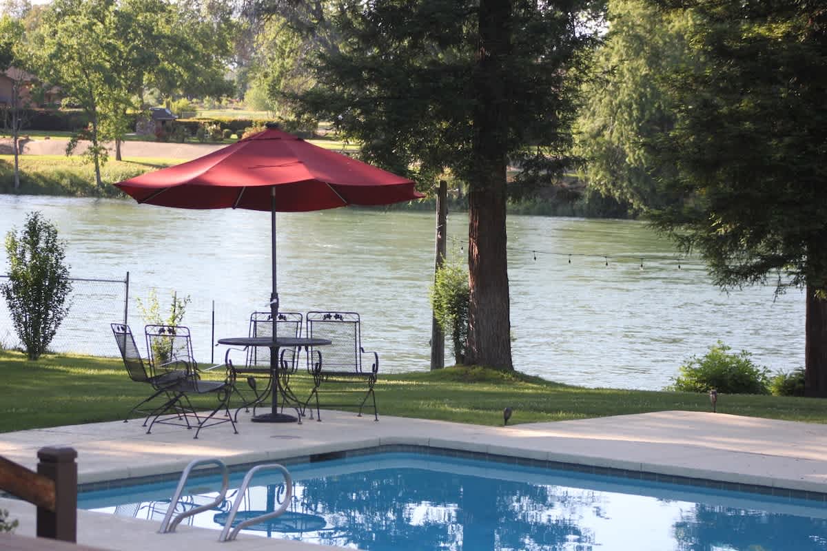 The Sacramento River is waiting for you to catch some fish. Then you can relax by the pool with your friends. It's 9 feet deep at its deepest point too. No, it's not heated. Only our hot tub is heated.