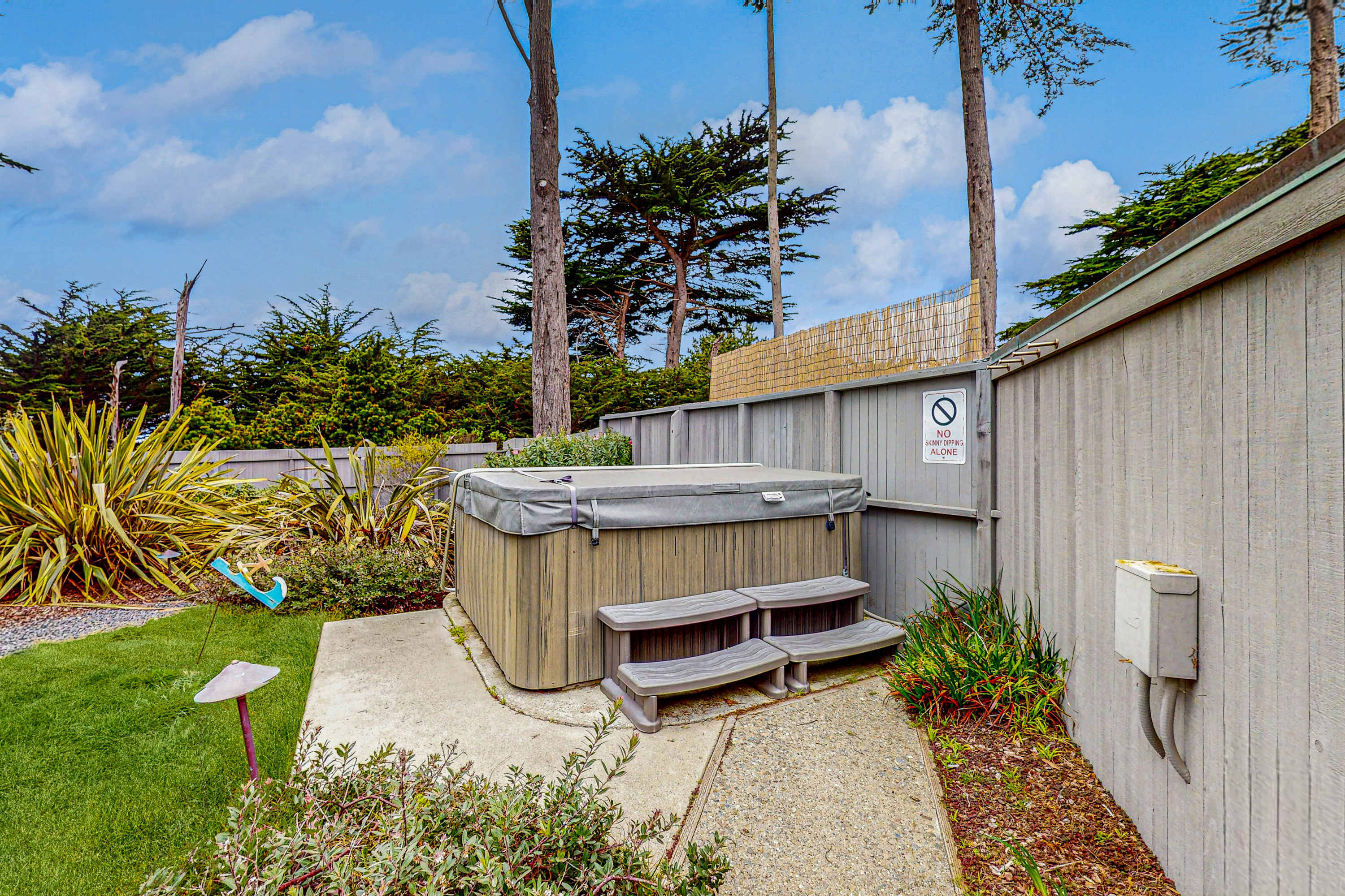 Soak in your private hot tub under the stars, the perfect spot to unwind after a day of coastal adventures.