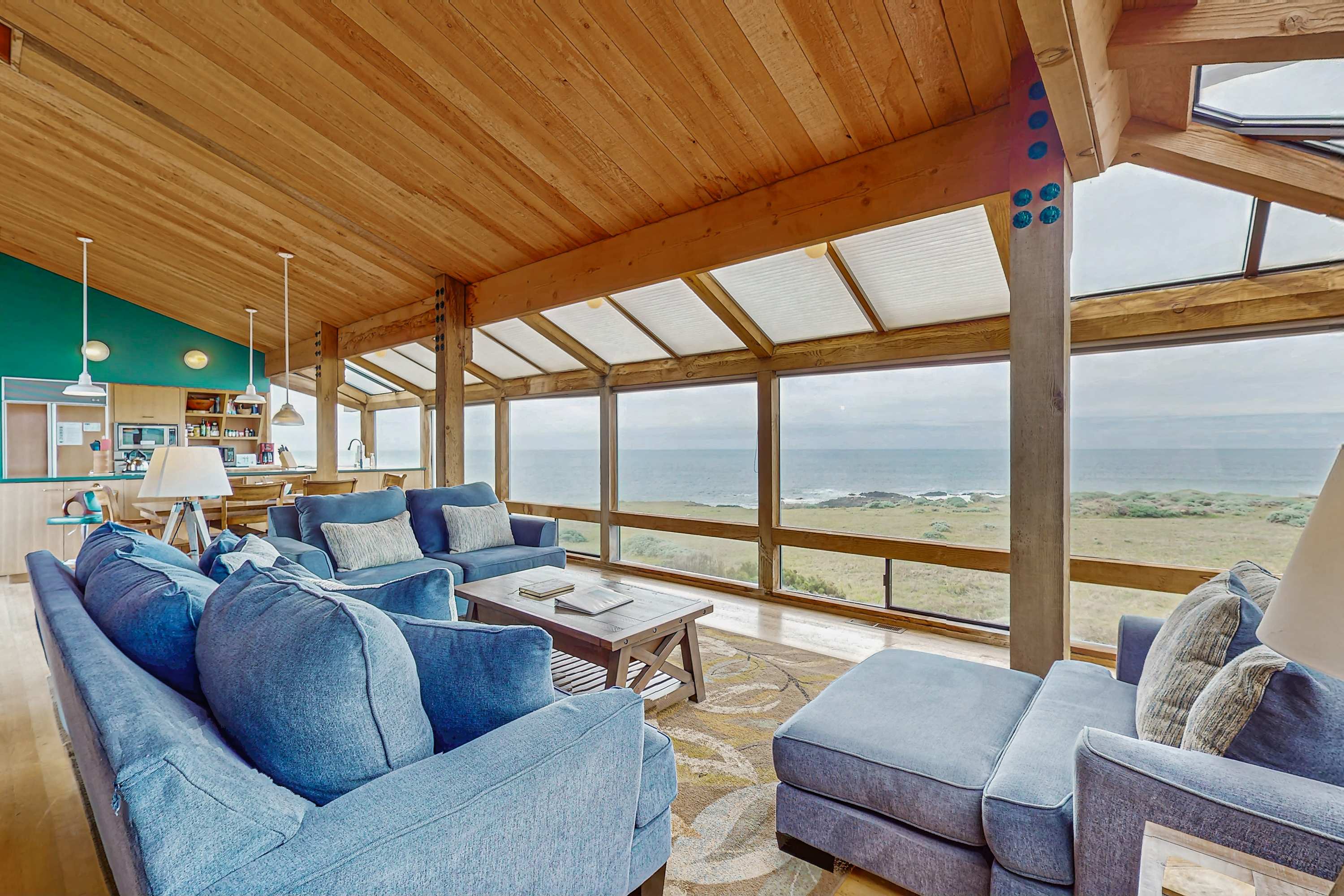 Morning light fills the spacious living room, where you can unwind with ocean views and comfy seating.