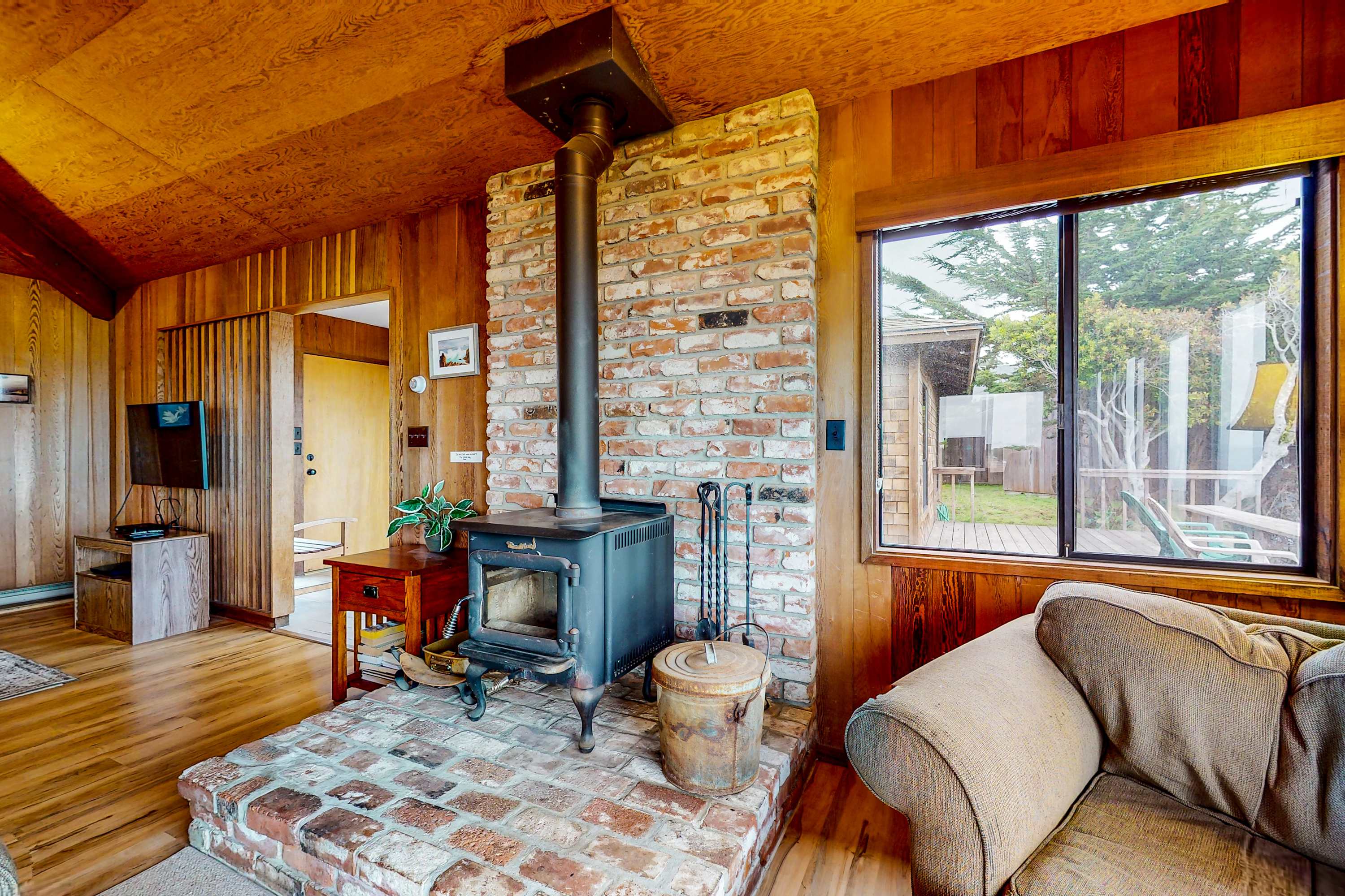 The rustic charm of the wood-burning stove adds warmth and character to your Sea Ranch retreat.