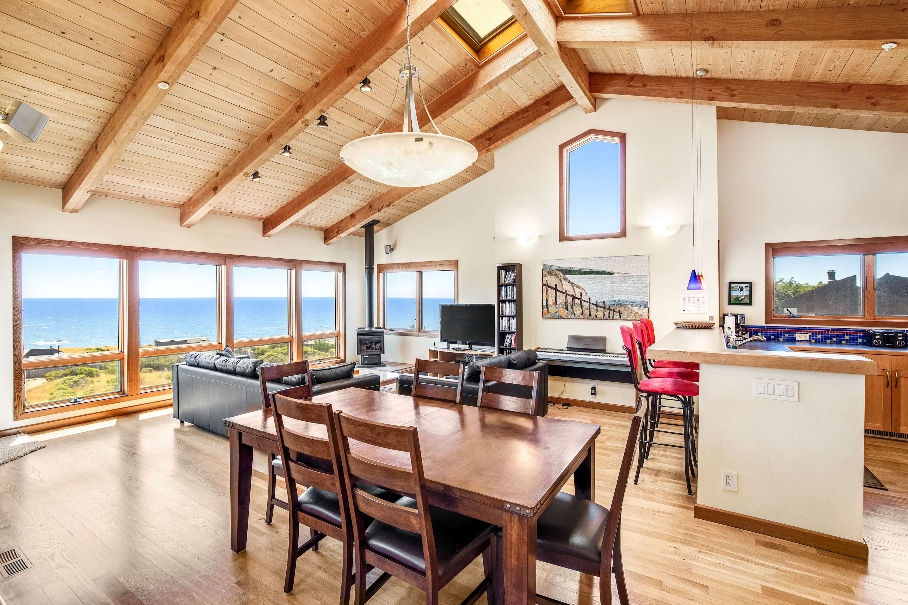 Gather around the dining table, where ocean views and shared meals create unforgettable memories with loved ones.