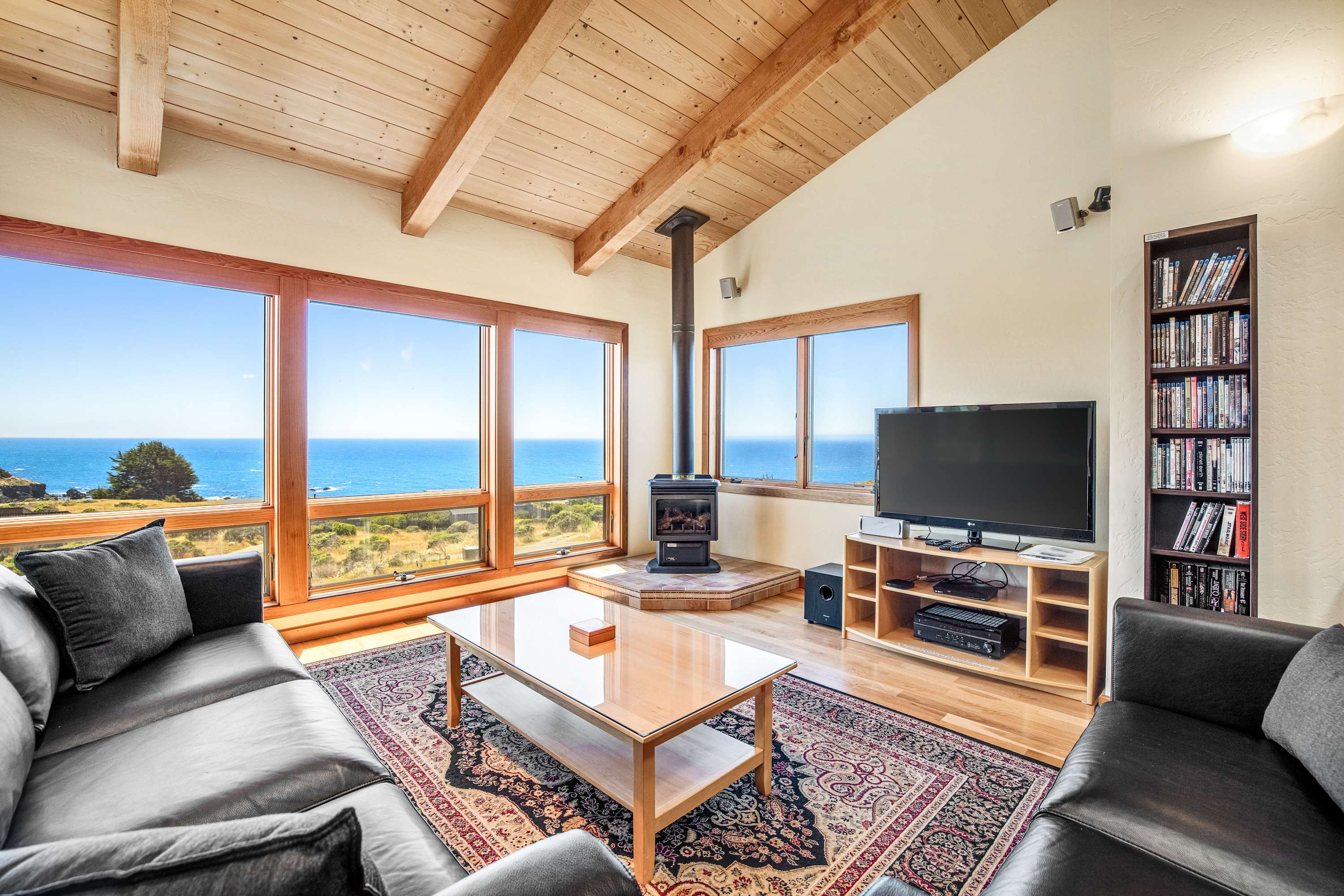 Gaze out at the ocean from your cozy living room, where the warmth of the gas fireplace invites relaxation after a day of adventure.