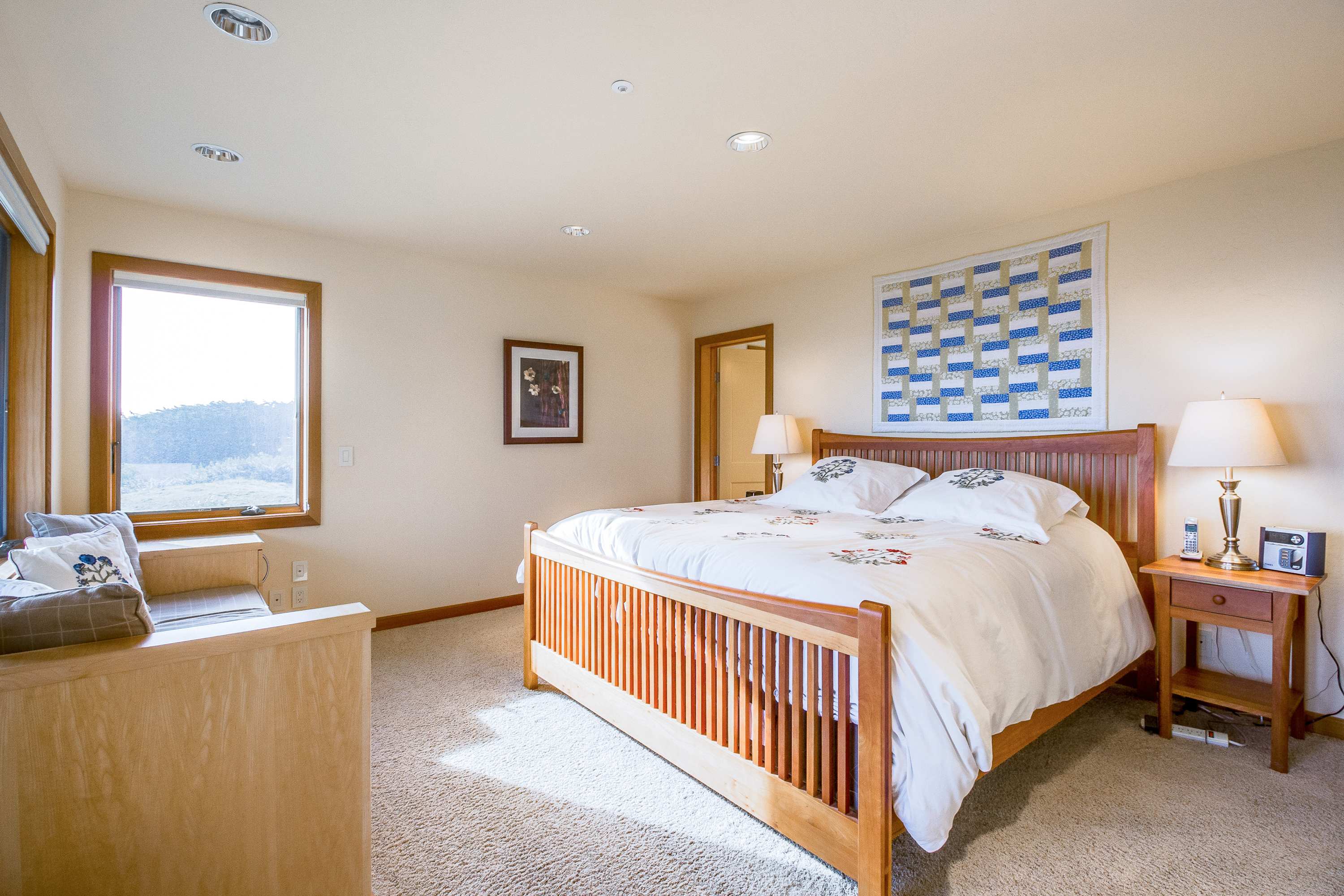 Your master bedroom awaits, a peaceful haven featuring plush bedding and views that invite you to unwind in coastal comfort.