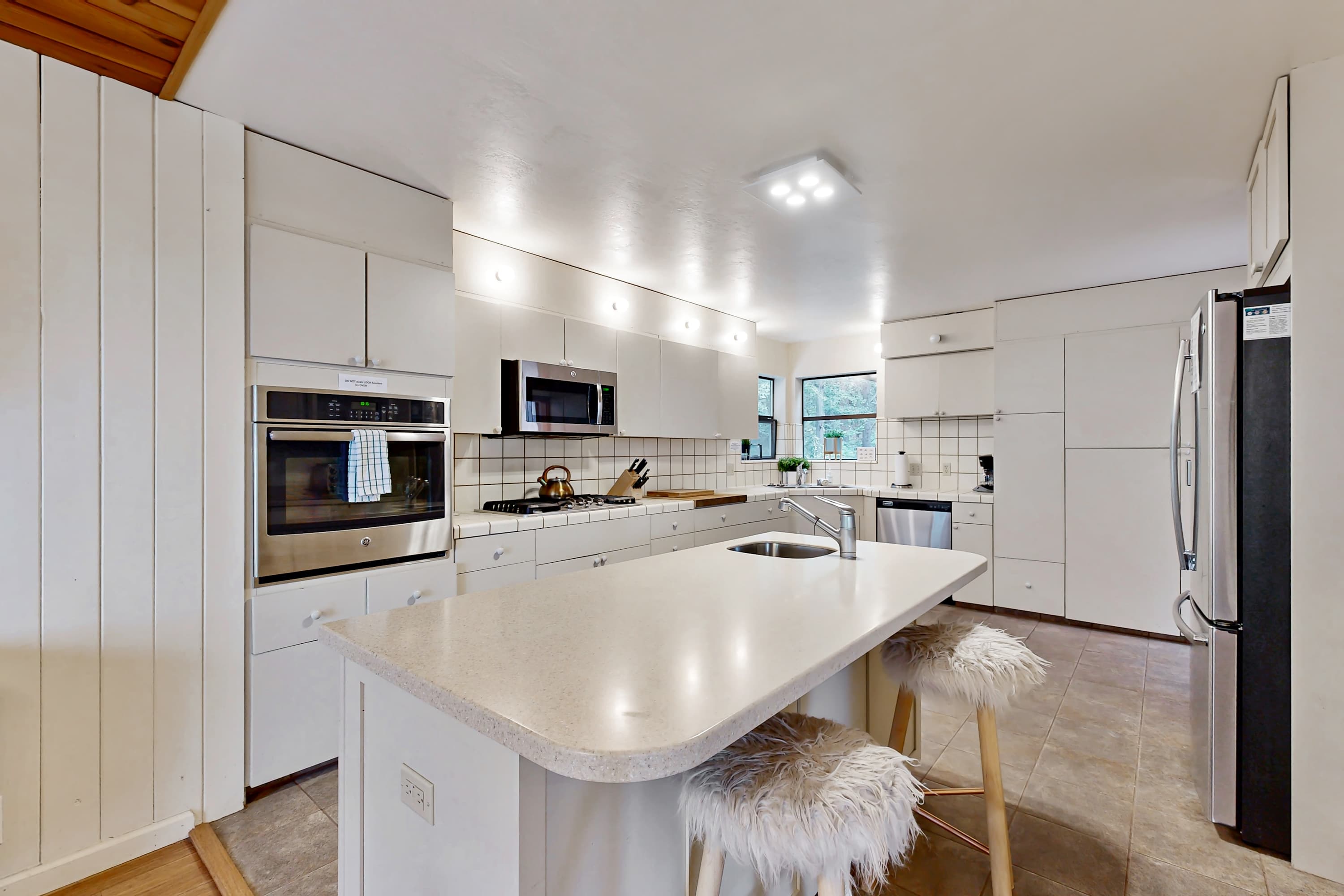 Cook up your favorite meals in this modern kitchen, designed for both functionality and style, making mealtime a delightful experience.
