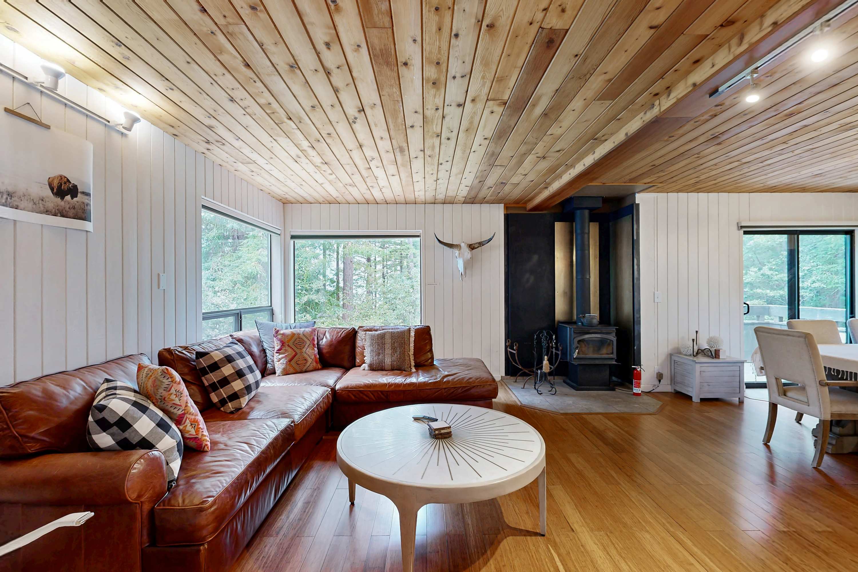 This inviting living room features a wood stove, perfect for cozy evenings spent with loved ones, sharing stories and laughter.
