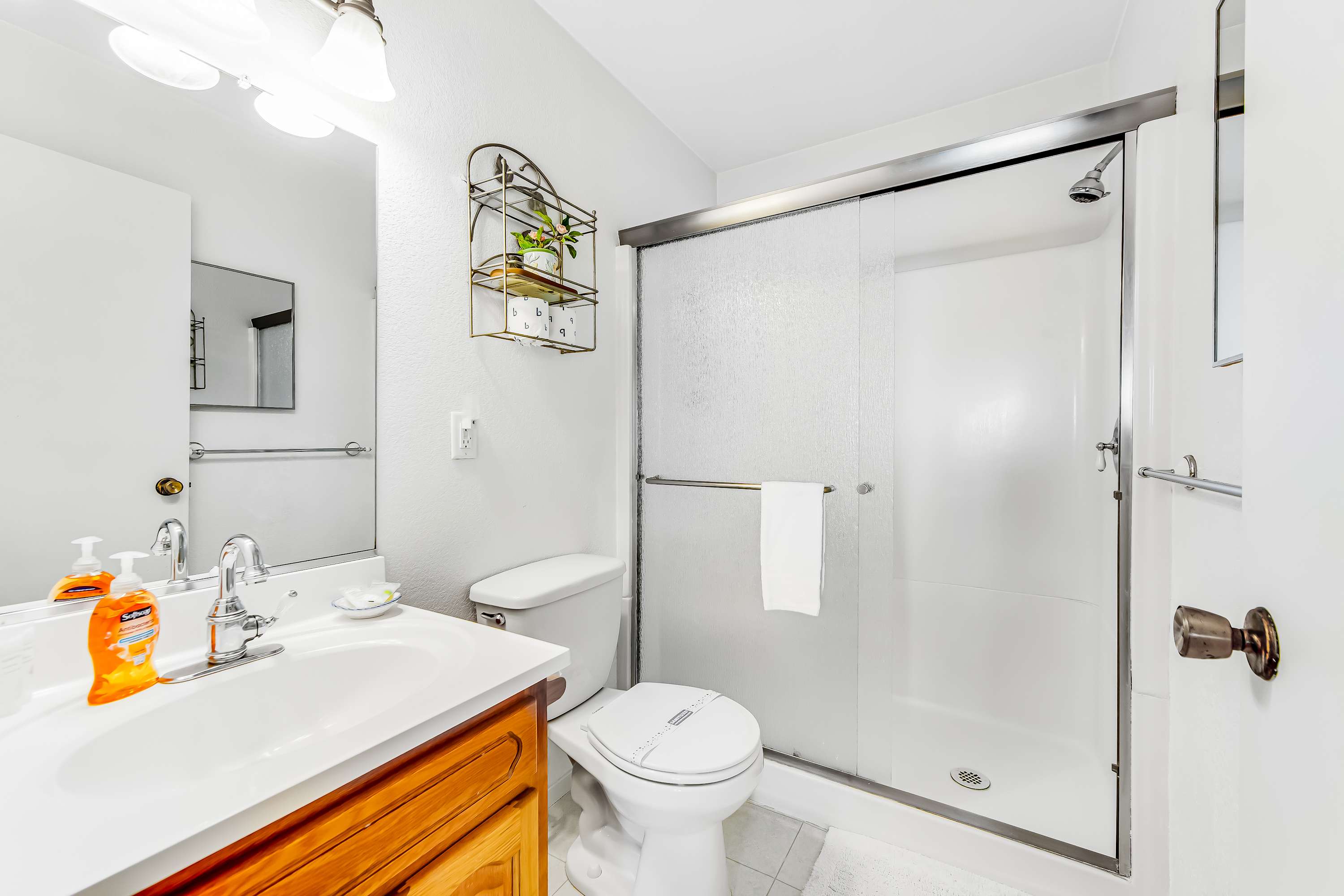 The bathroom features modern fixtures and a clean design, providing a refreshing space to prepare for your coastal adventures.
