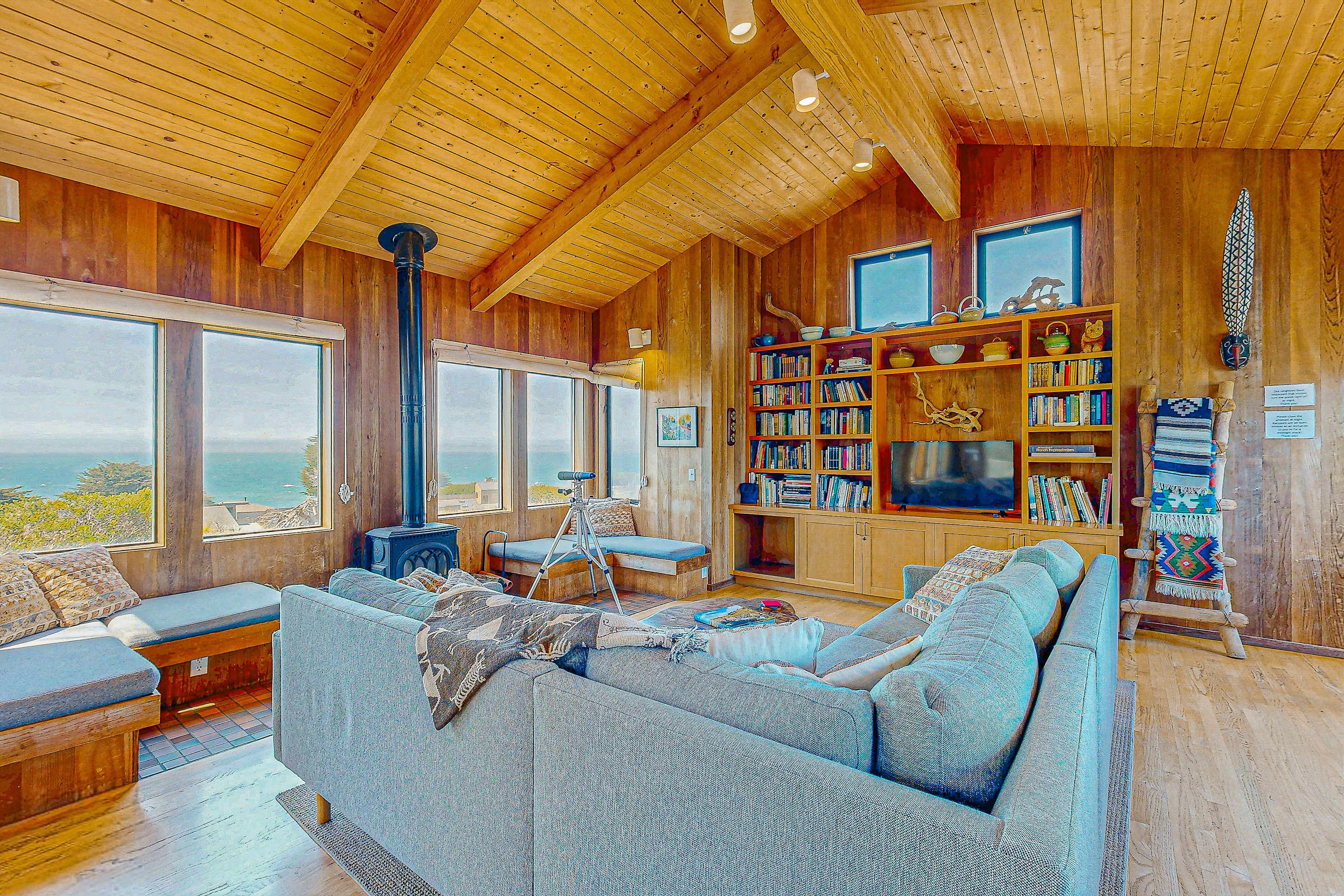 Breathe in the coastal air as you lounge in the cozy living room, where every window frames a piece of paradise.