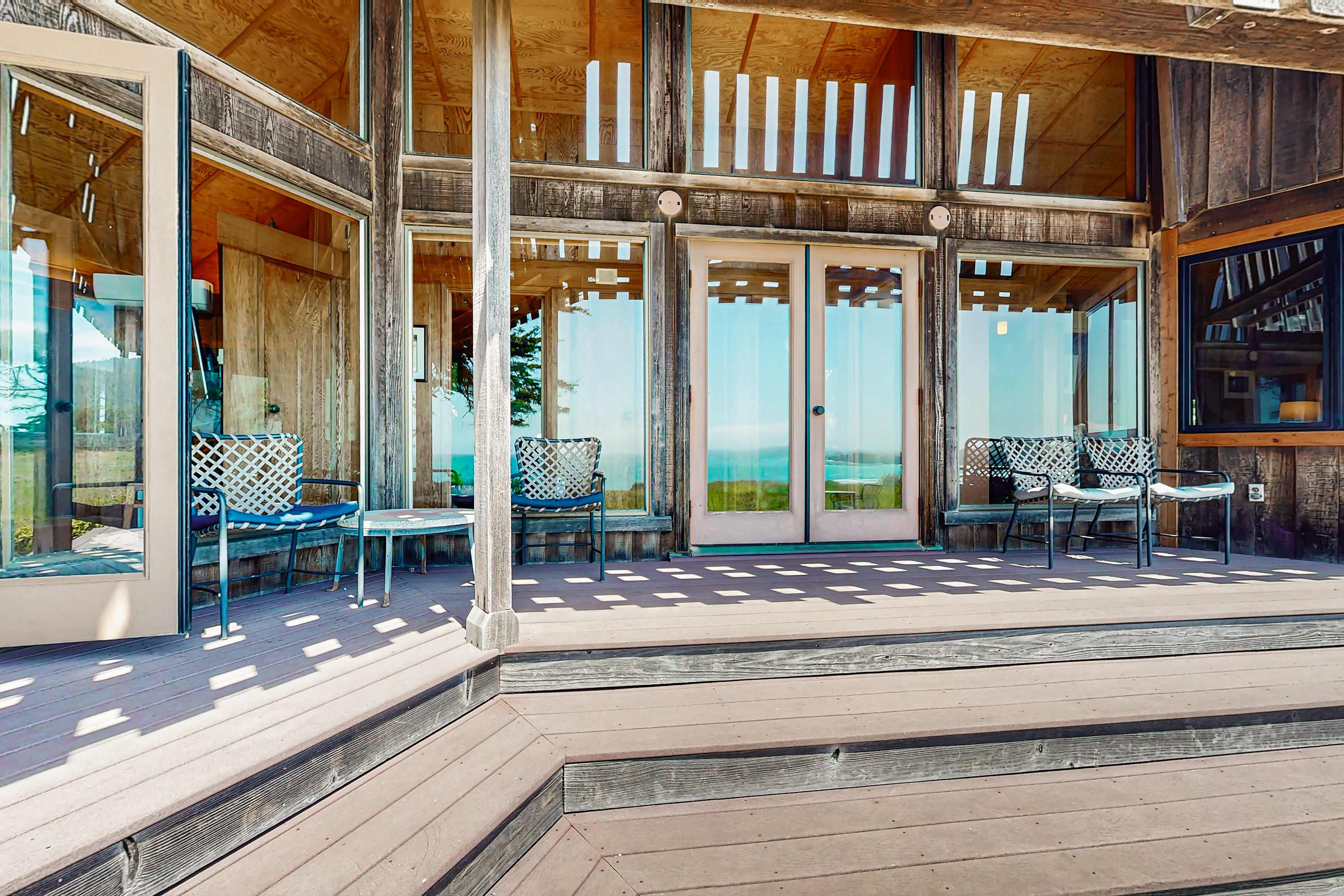 Step out onto the expansive deck, where comfortable seating invites you to soak in ocean views and the beauty of coastal living.