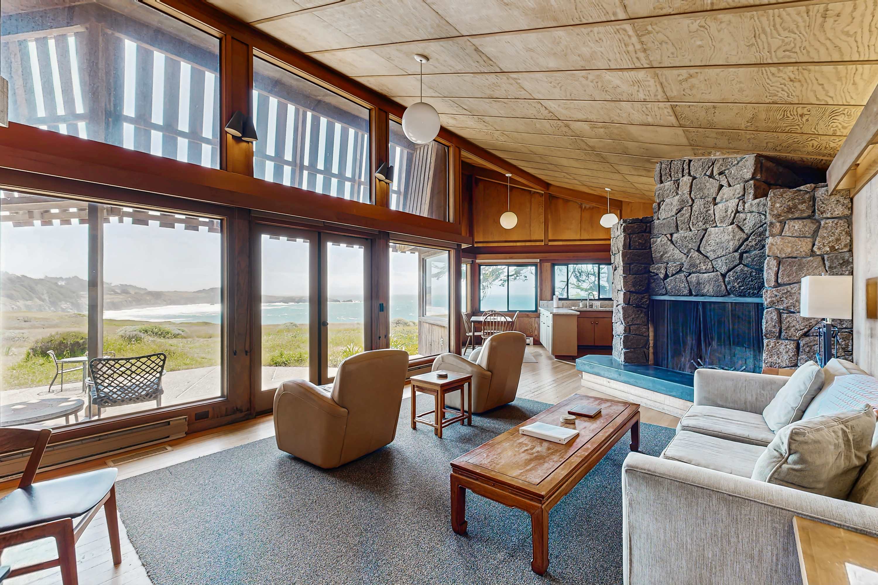Relax in the spacious living room, where natural light pours in and the wood-burning fireplace invites cozy evenings.