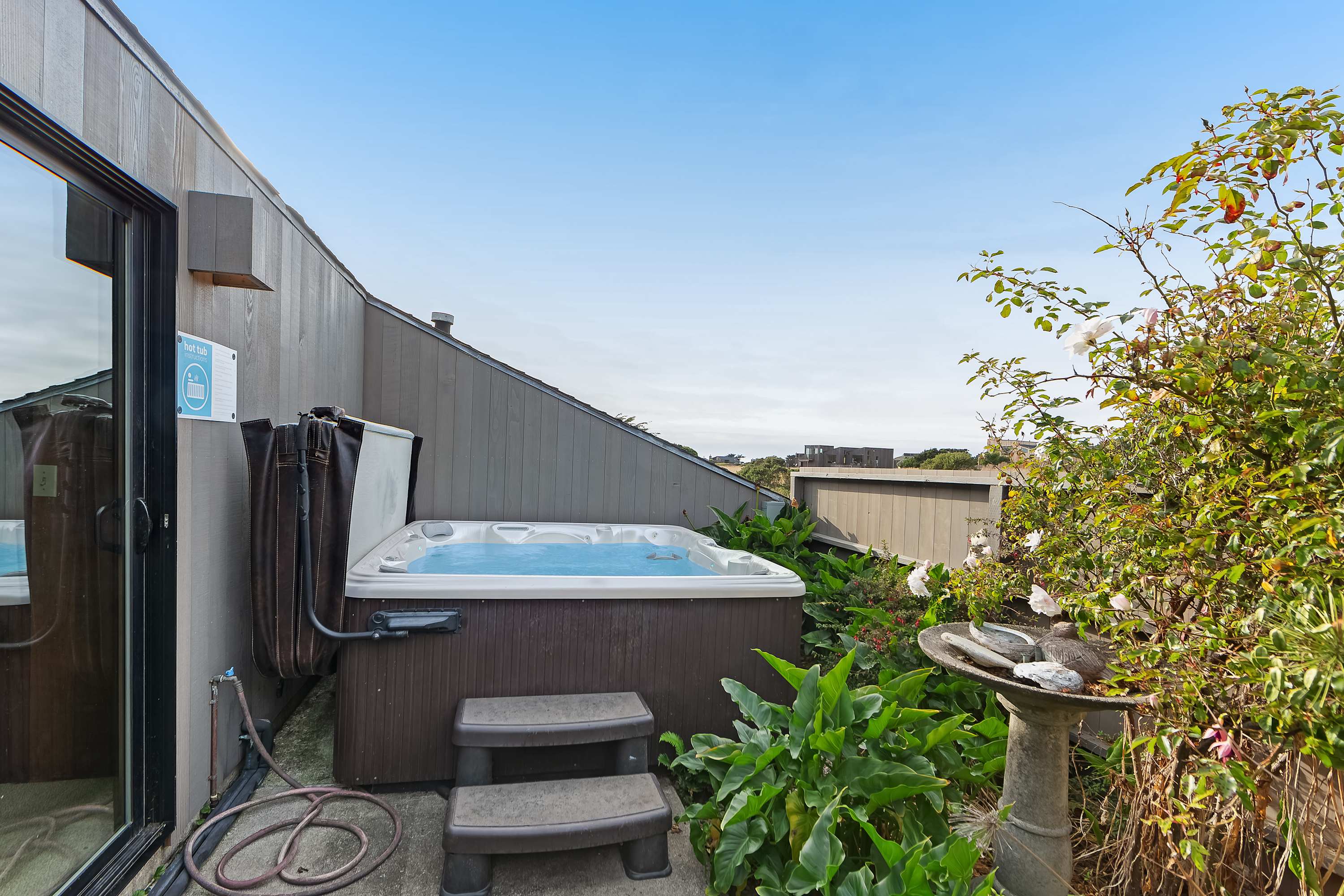 After a day of exploration, unwind in your private hot tub, surrounded by lush greenery and ocean breezes.