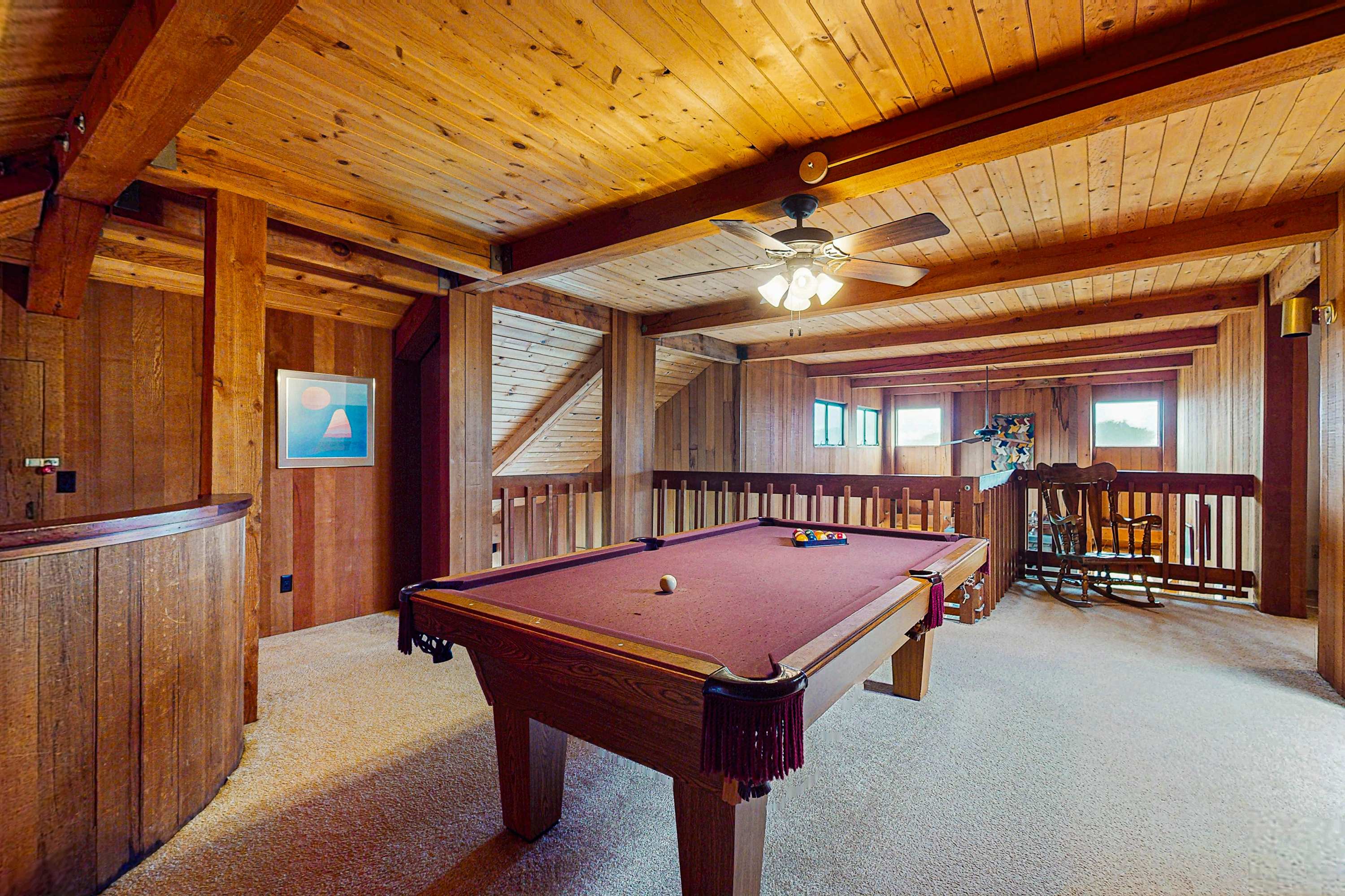 Challenge your friends to a game of pool in the cozy game room, perfect for friendly competition.