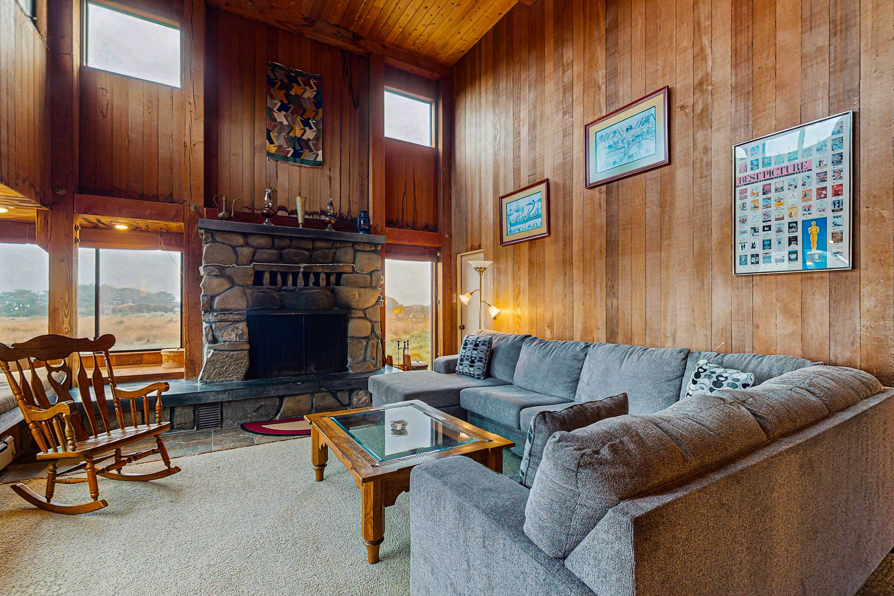Gather around the wood-burning fireplace in the spacious living room, where warmth and relaxation await.