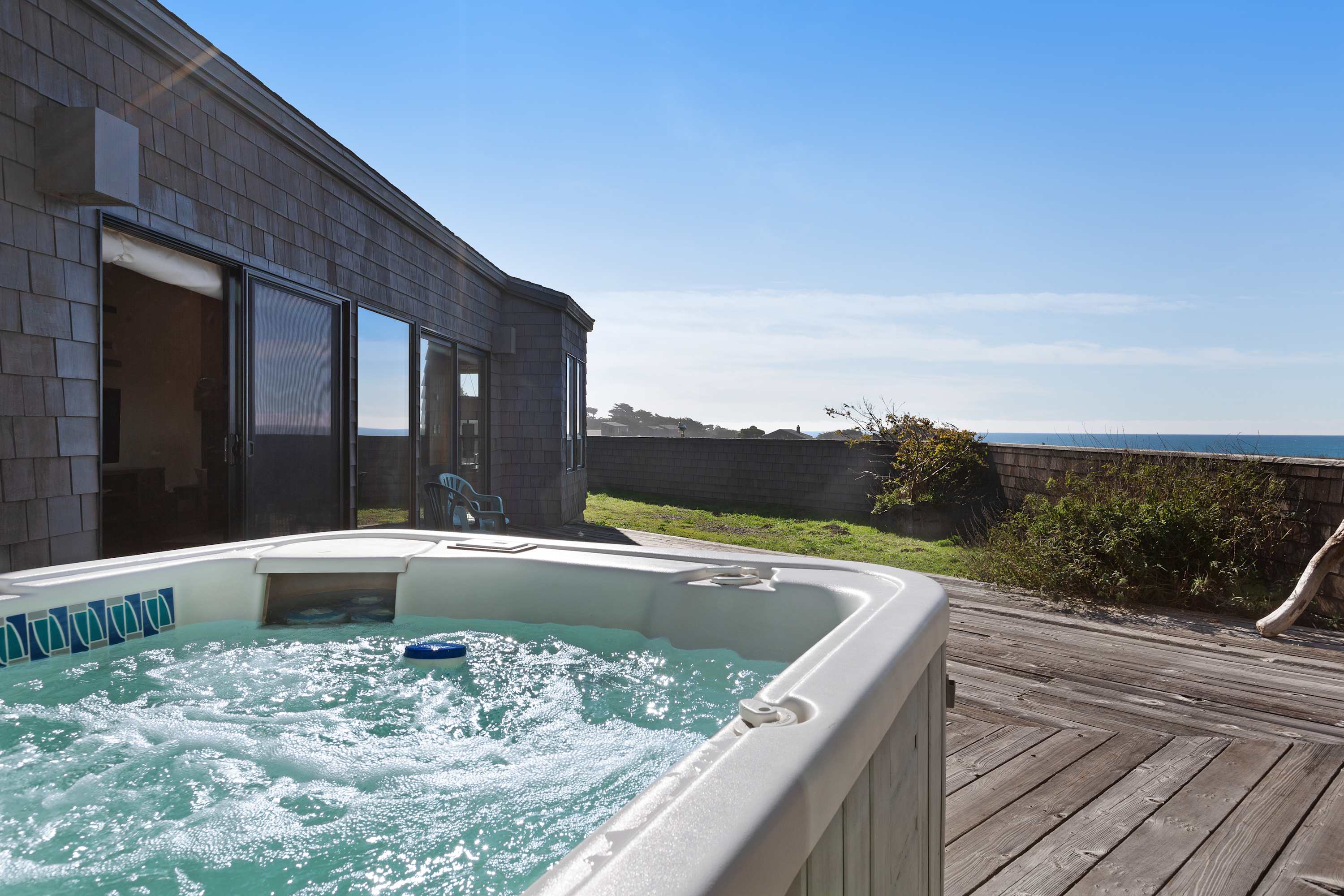Soak in your private hot tub while enjoying breathtaking ocean views—perfect for unwinding after a day of exploring.