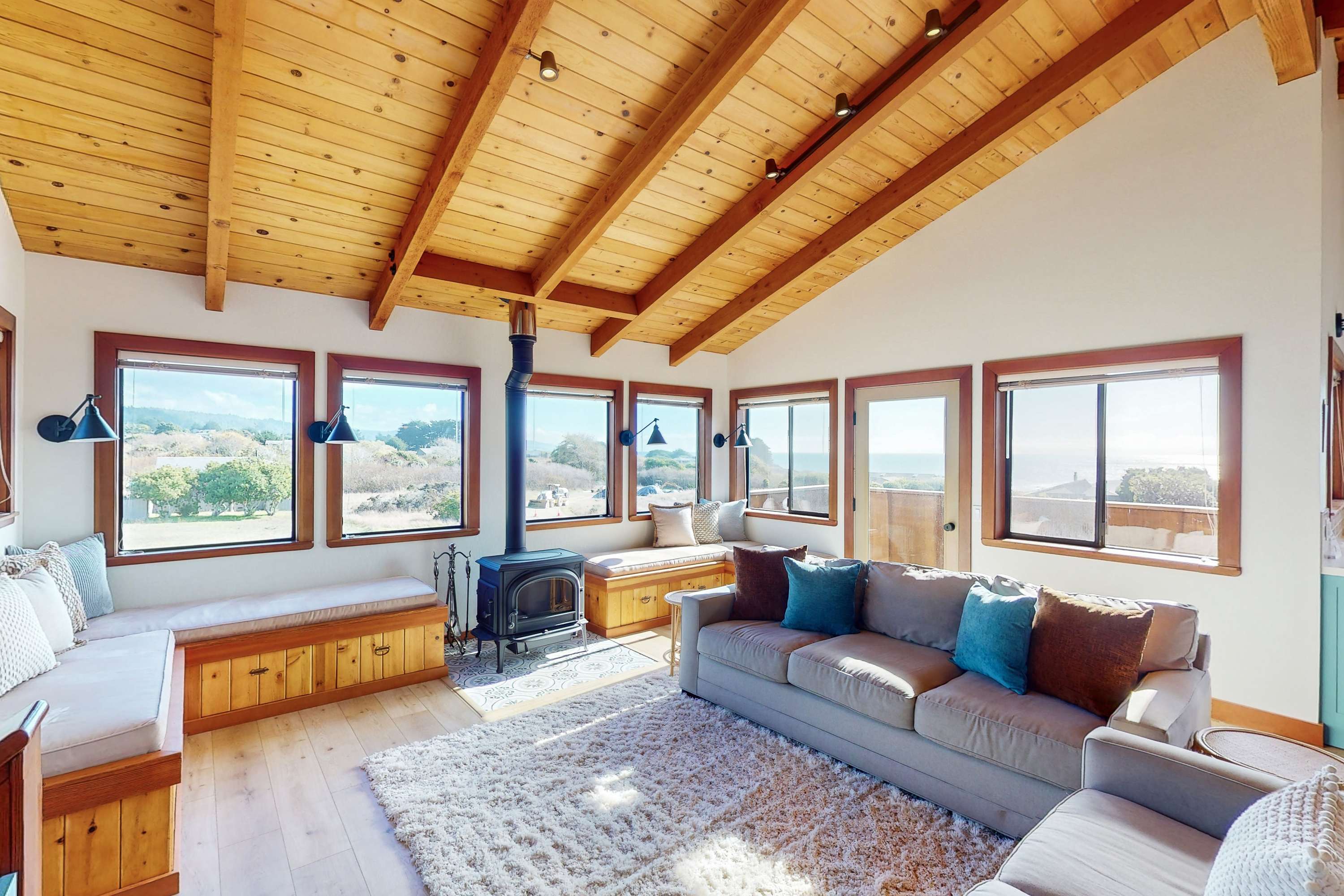 With panoramic windows framing stunning vistas, this inviting living room is designed for both relaxation and entertaining.
