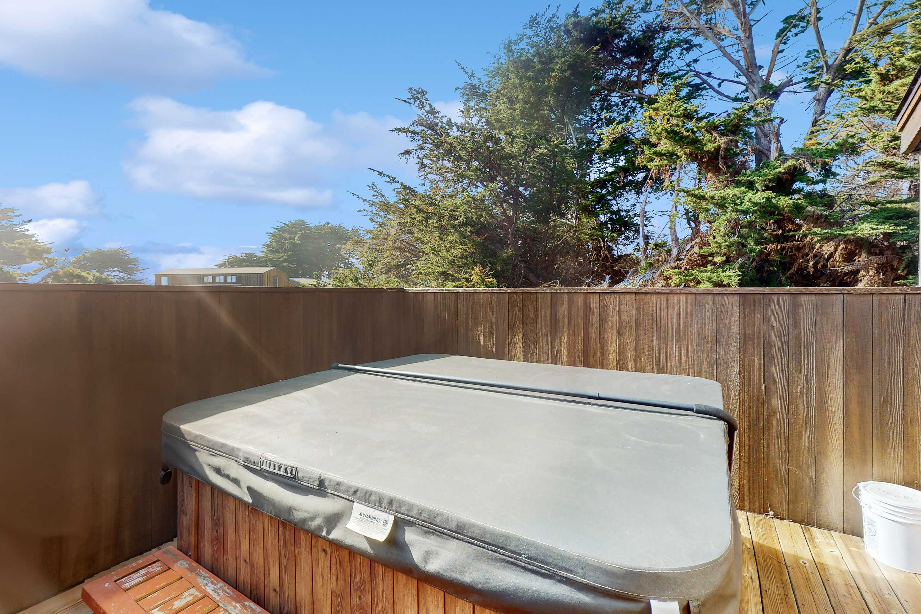 Your private hot tub awaits, offering a perfect retreat to unwind under the stars after a day of coastal adventures.