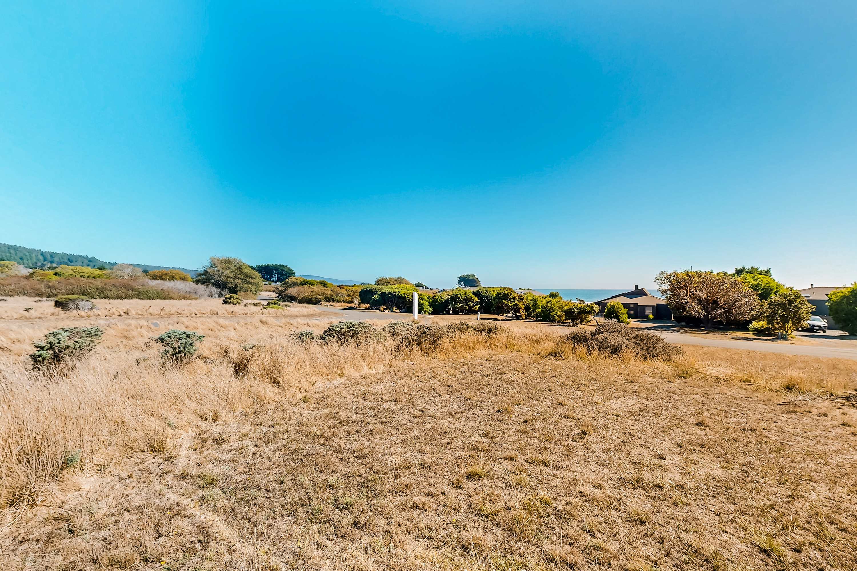 Gaze across the open landscape, where the beauty of Sea Ranch unfolds, inviting you to explore nearby trails and beaches.
